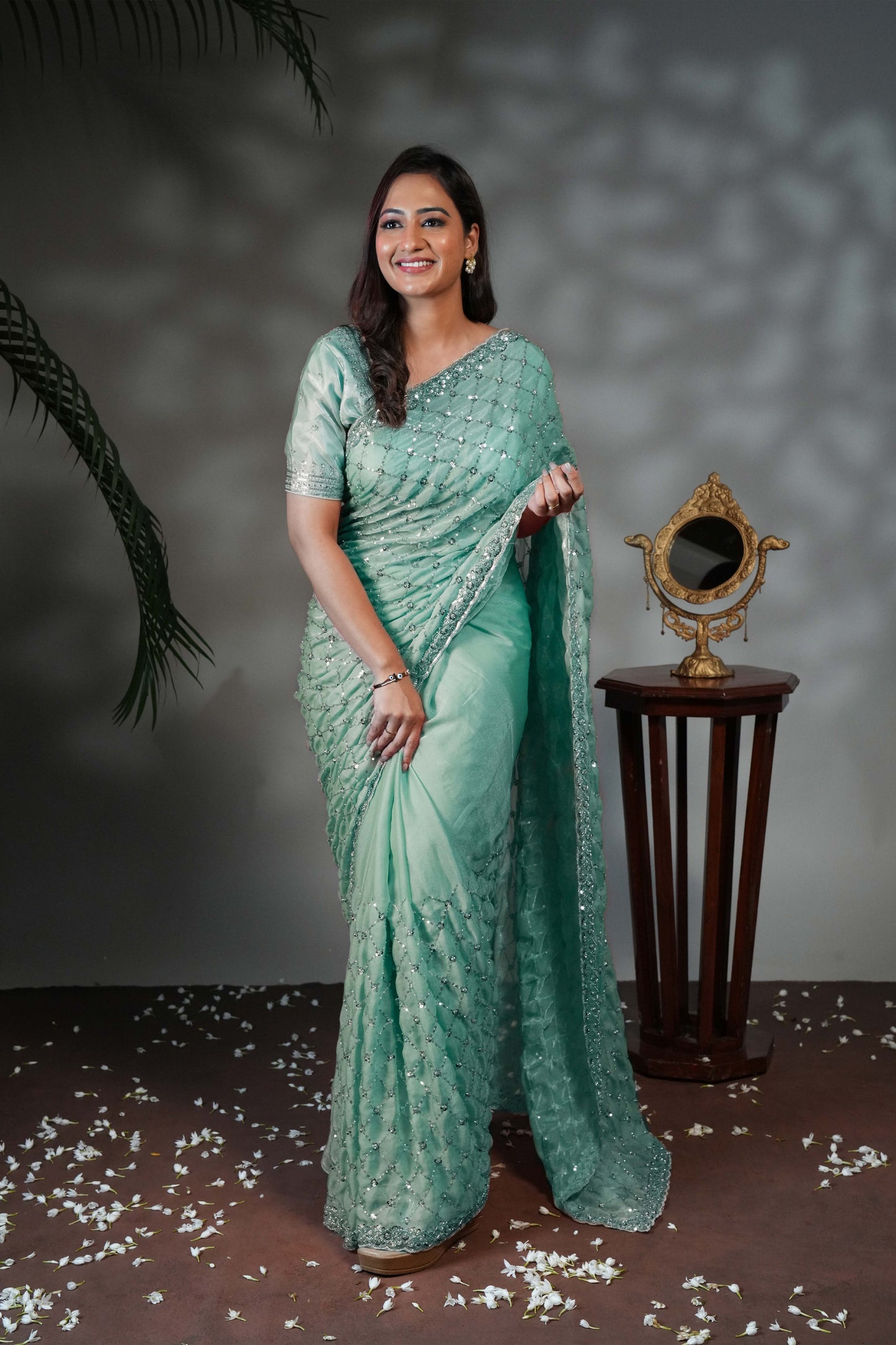 Turquoise green geometric pattern stone work all over body designer saree with scallop design border matching blouse