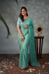 Turquoise green geometric pattern stone work all over body designer saree with scallop design border matching blouse