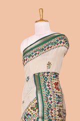 Cream chanderi cotton saree with geometric floral butta, green zari border and patola inspired mirror work