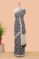 Black assam silk saree with all over ikkat style print, stripe pallu and zari border