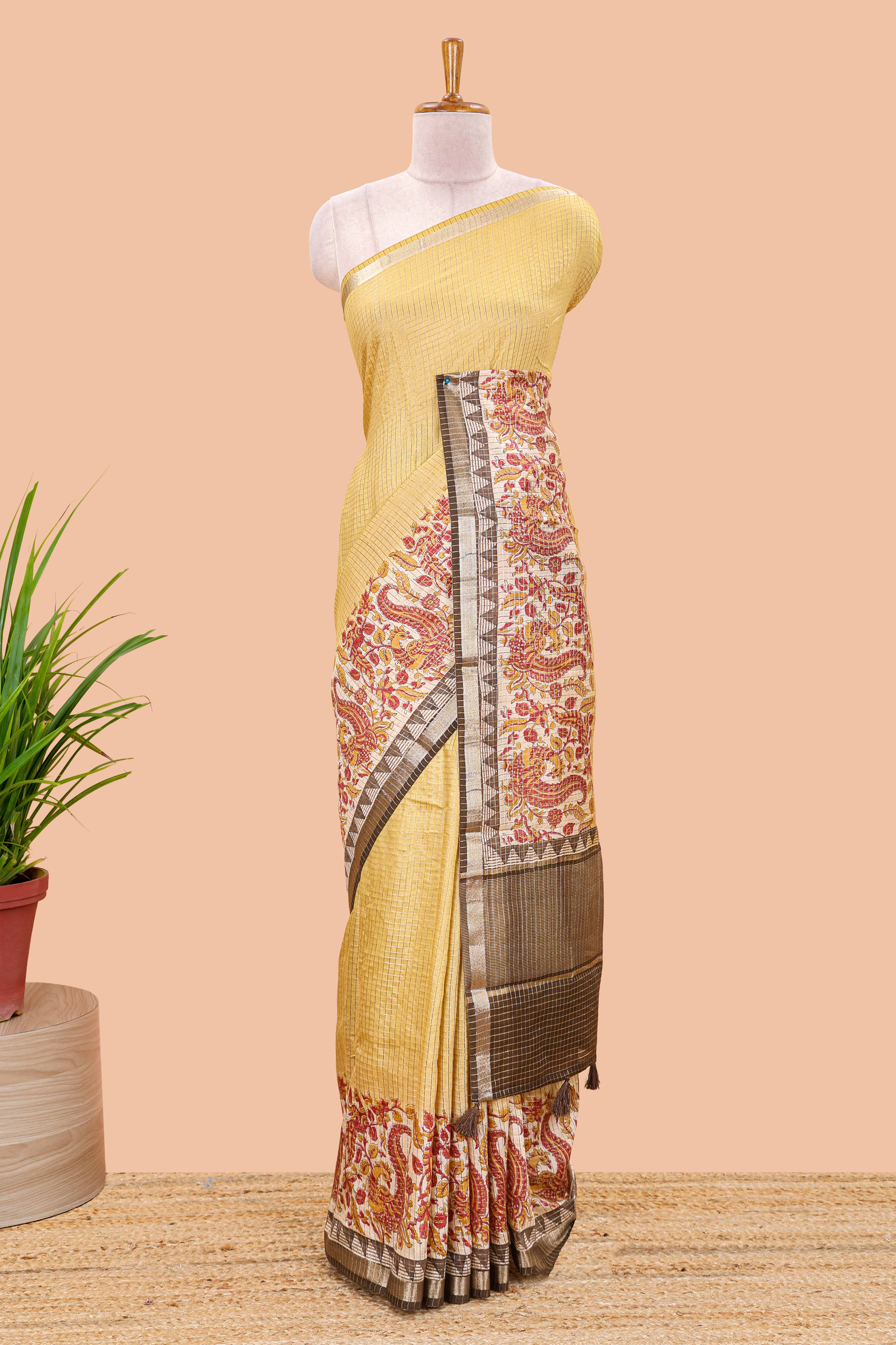 Mustard assam silk saree with zari check, floral & peacock motifs, kalamkari print border and striped pallu