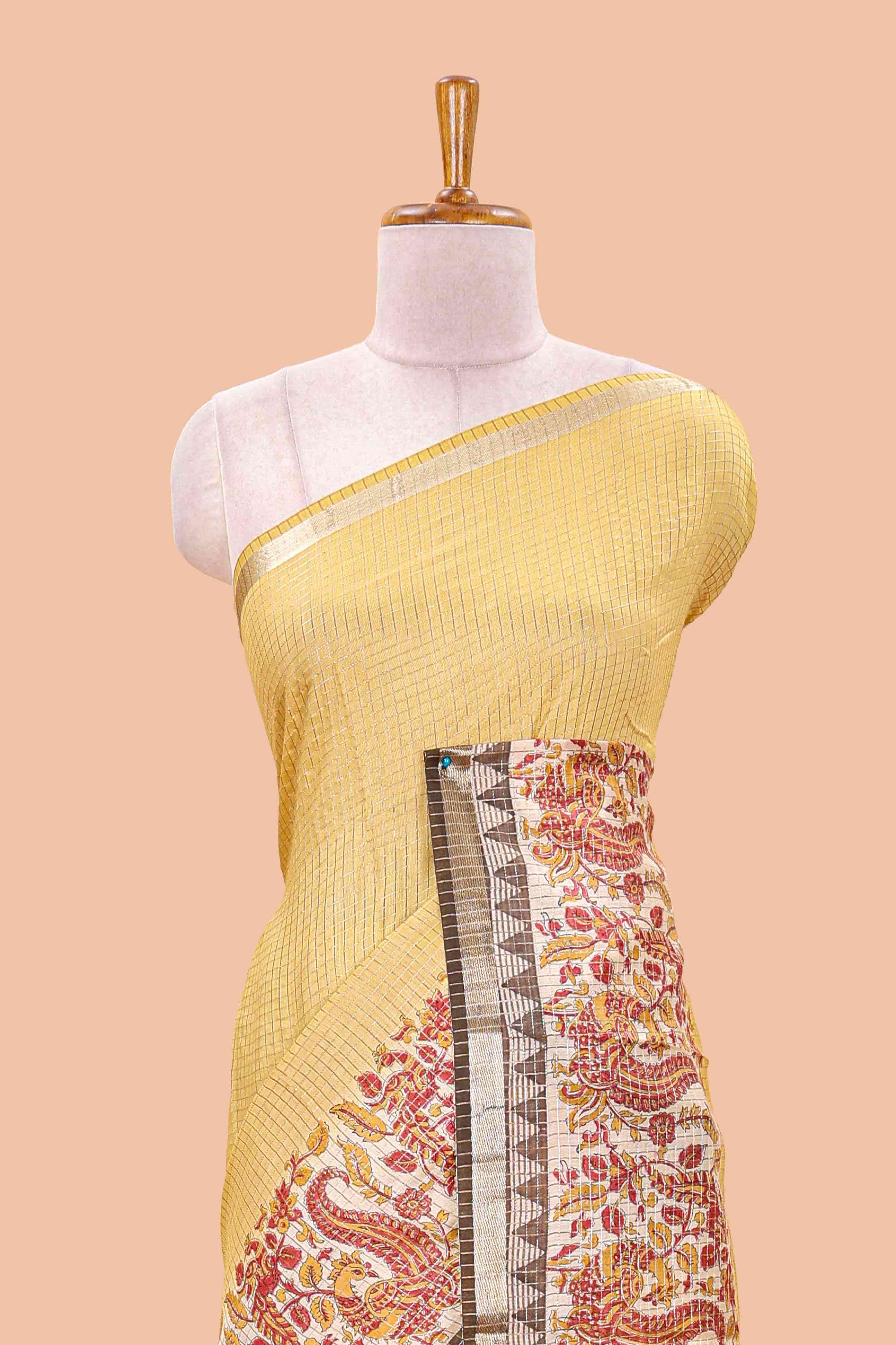 Mustard assam silk saree with zari check, floral & peacock motifs, kalamkari print border and striped pallu