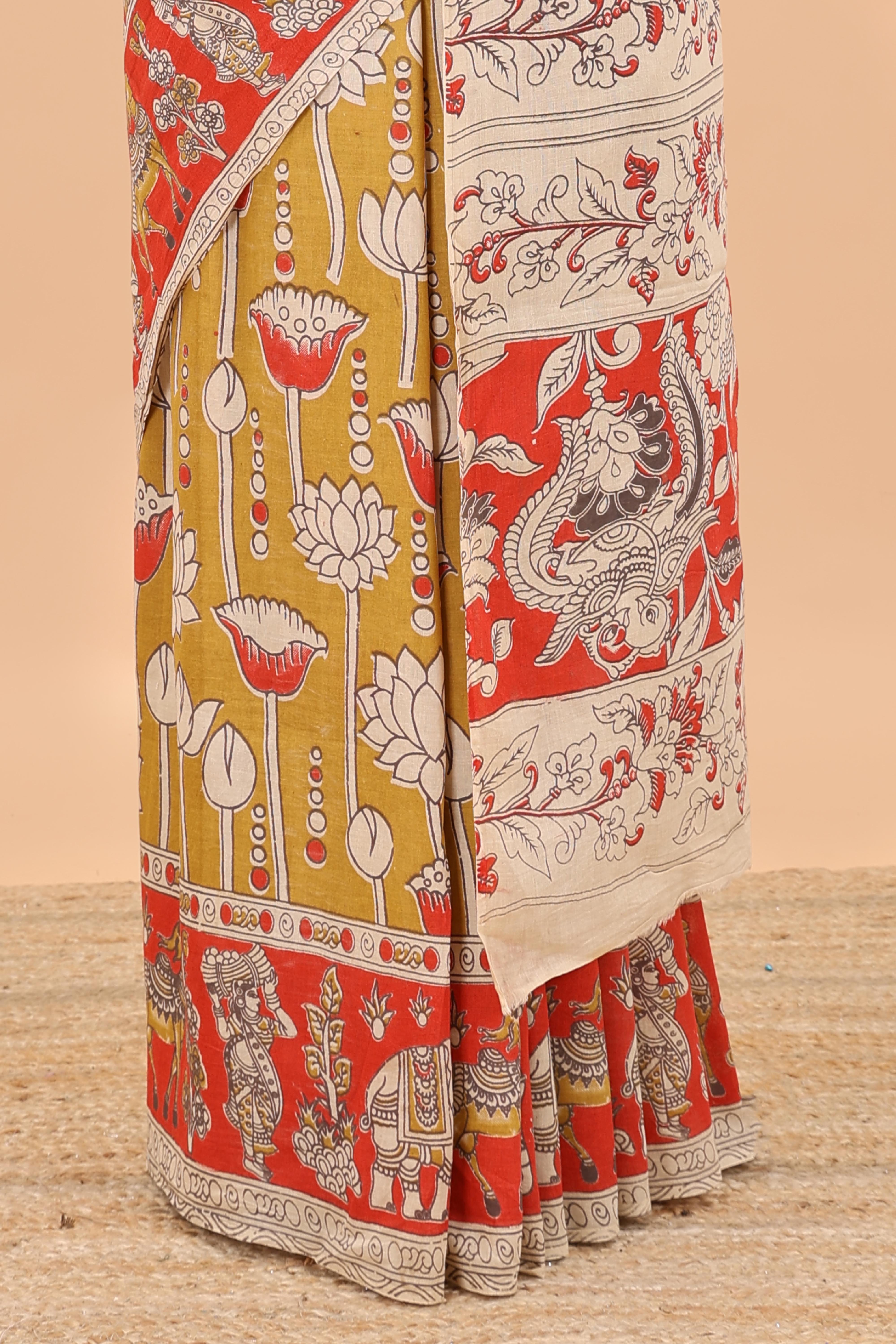 Mustard kalamkari printed cotton saree with traditional floral motifs and contrast pallu