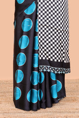 Black satin modal saree with blue polka print, contrast checked pallu, and printed blouse