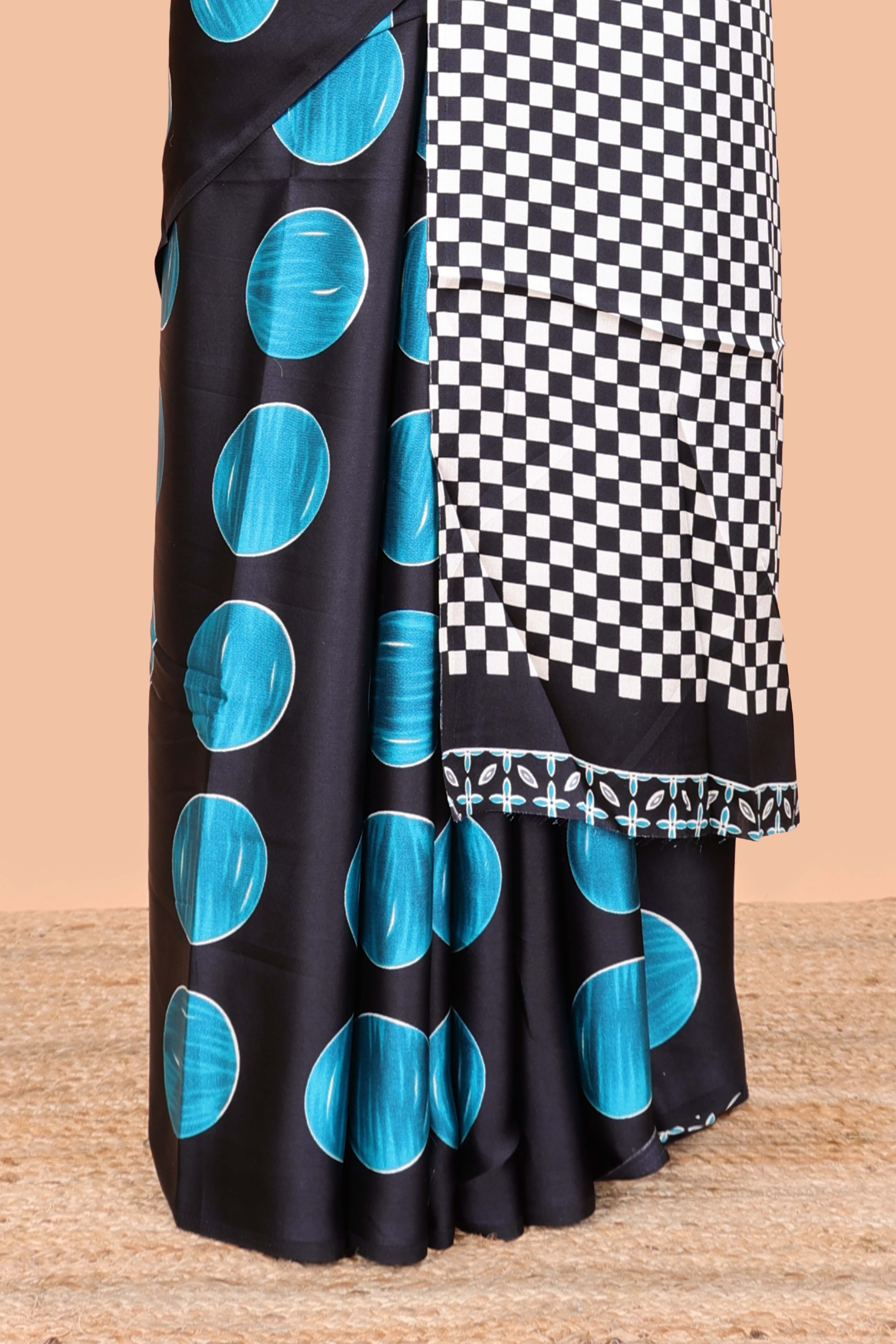 Black satin modal saree with blue polka print, contrast checked pallu, and printed blouse