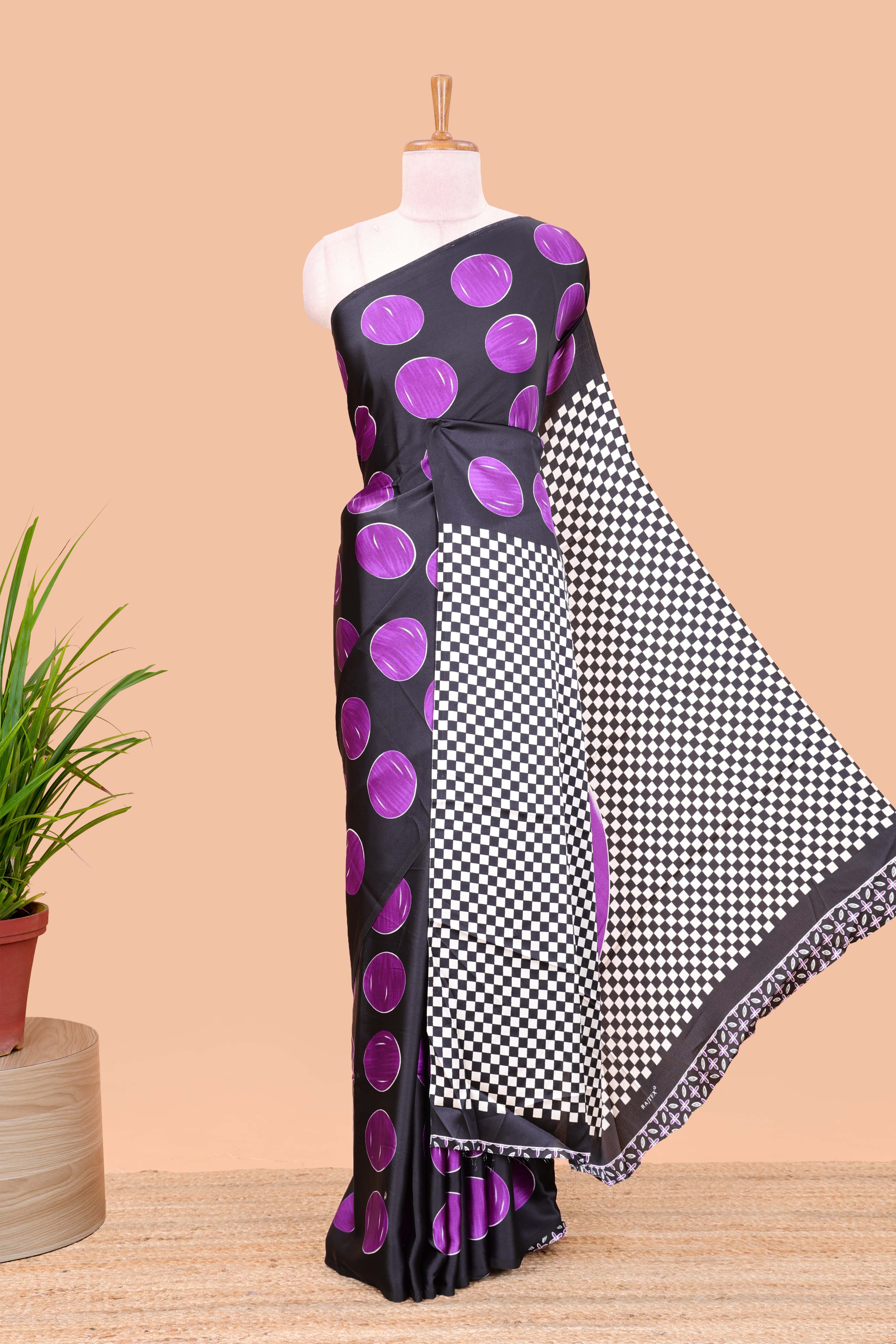 Black satin modal saree with purple polka print, contrast checked pallu, and printed blouse