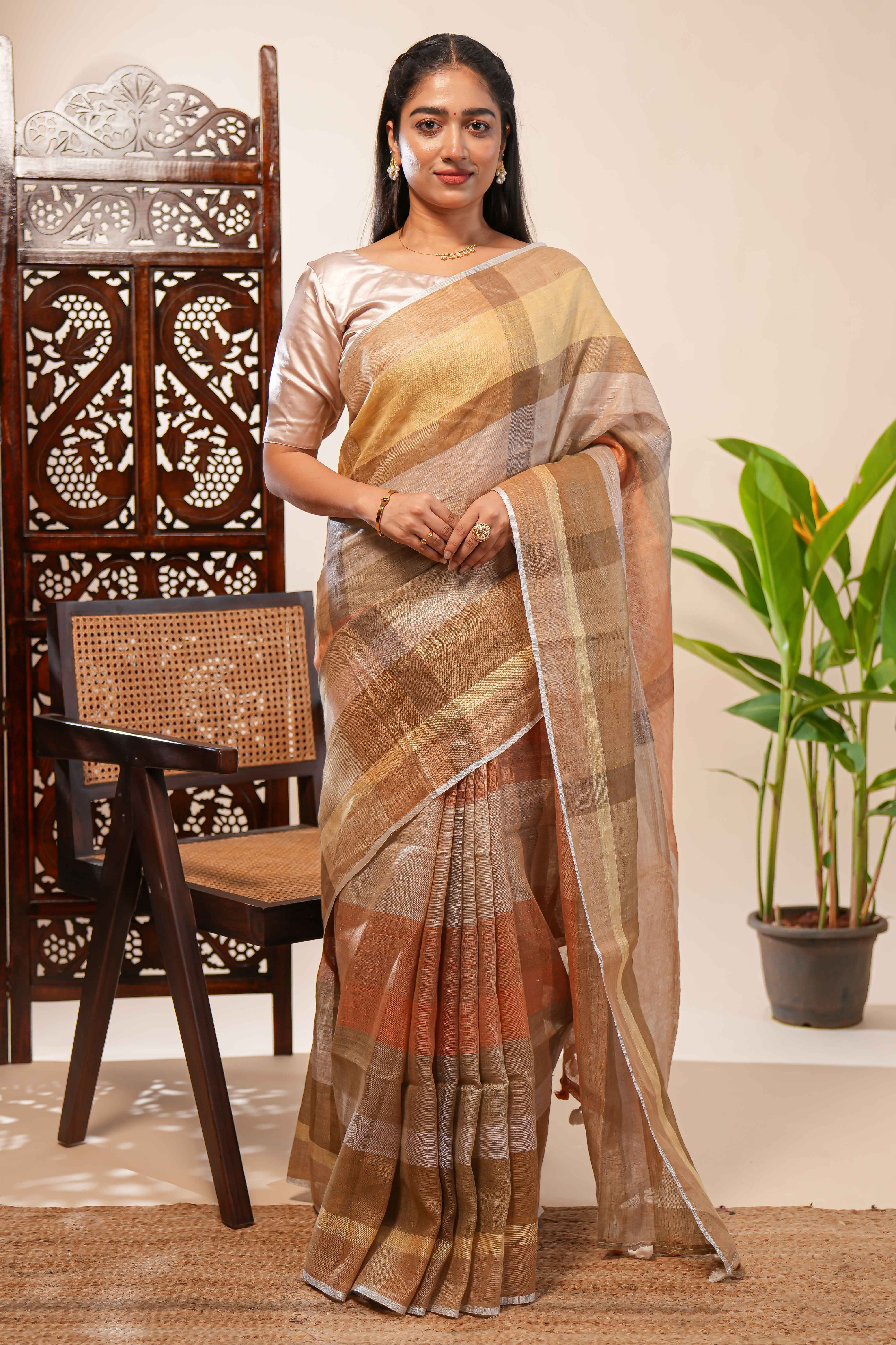 Brown Tones semi tussarall over saree Subtle Stripe and Checked pattern along with Tassels and Contrast Blouse