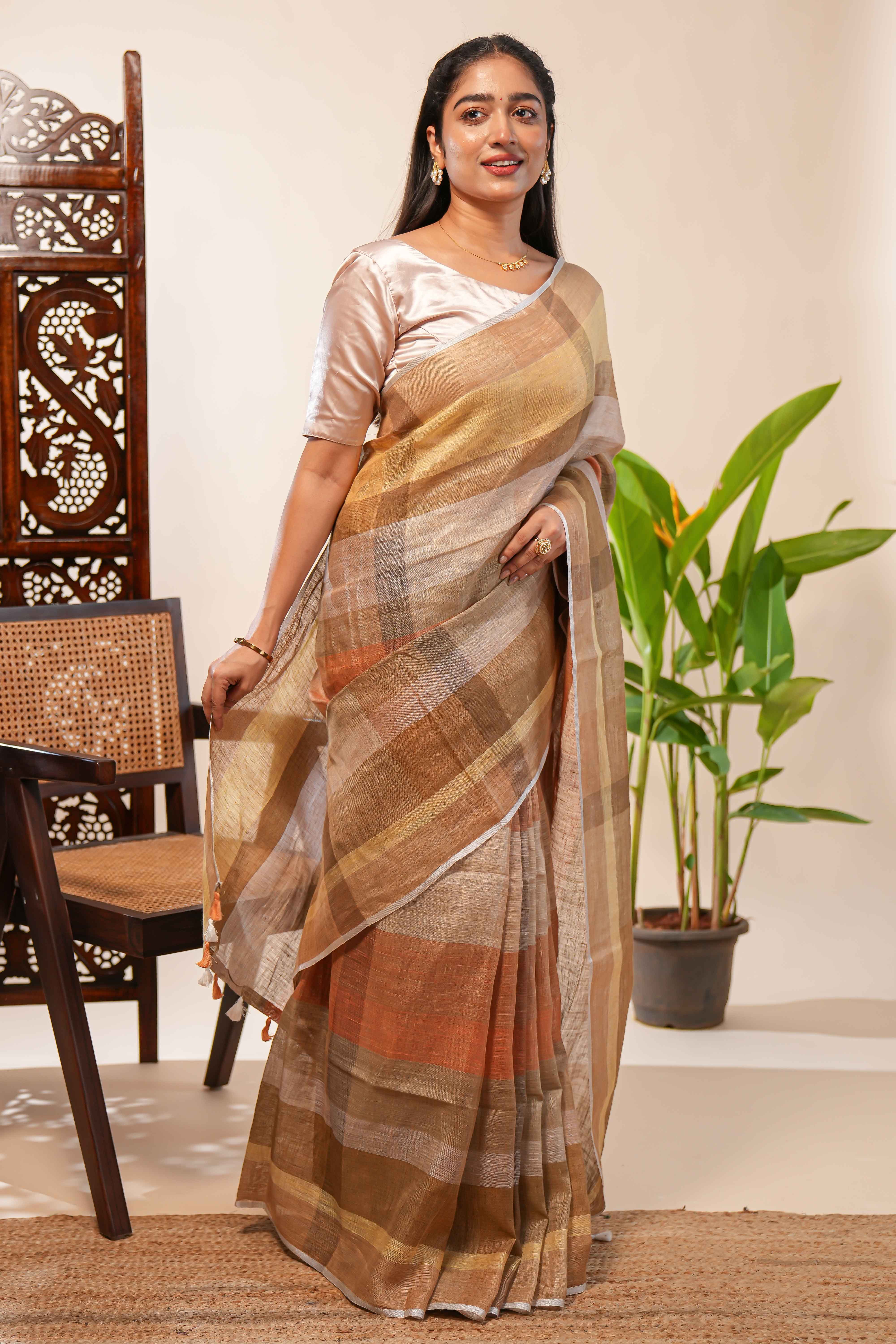 Brown Tones semi tussarall over saree Subtle Stripe and Checked pattern along with Tassels and Contrast Blouse