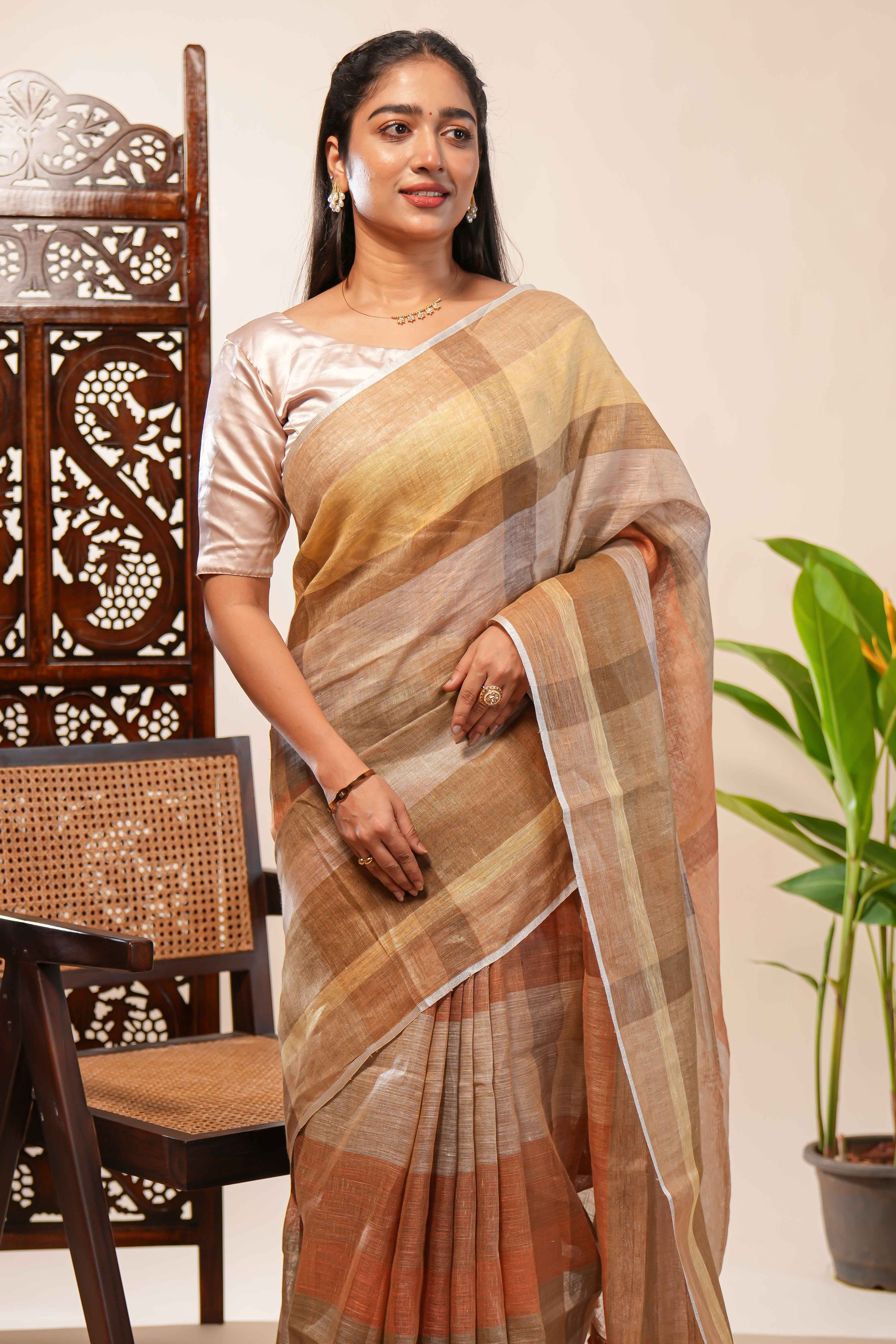 Brown Tones semi tussarall over saree Subtle Stripe and Checked pattern along with Tassels and Contrast Blouse