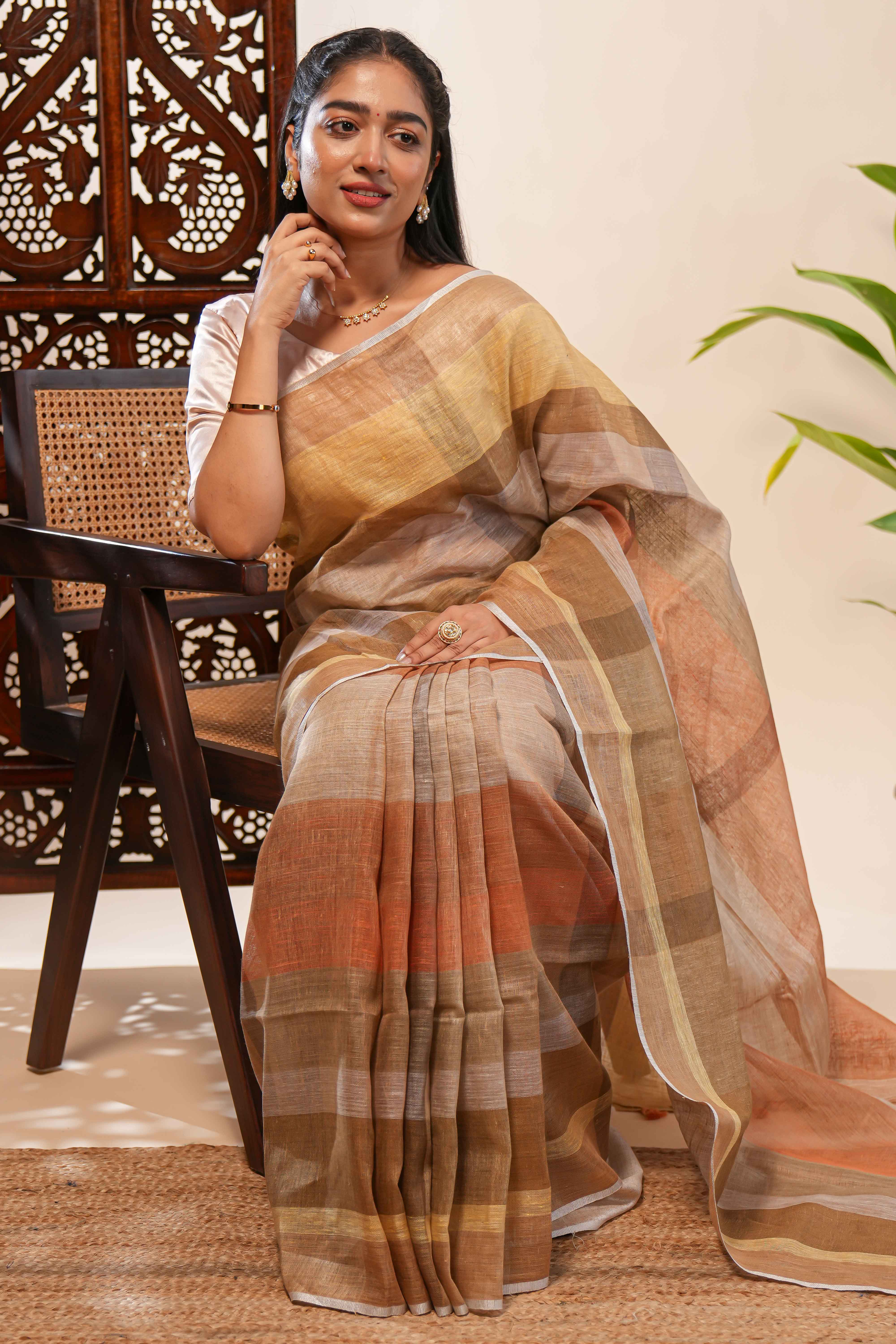 Brown Tones semi tussarall over saree Subtle Stripe and Checked pattern along with Tassels and Contrast Blouse