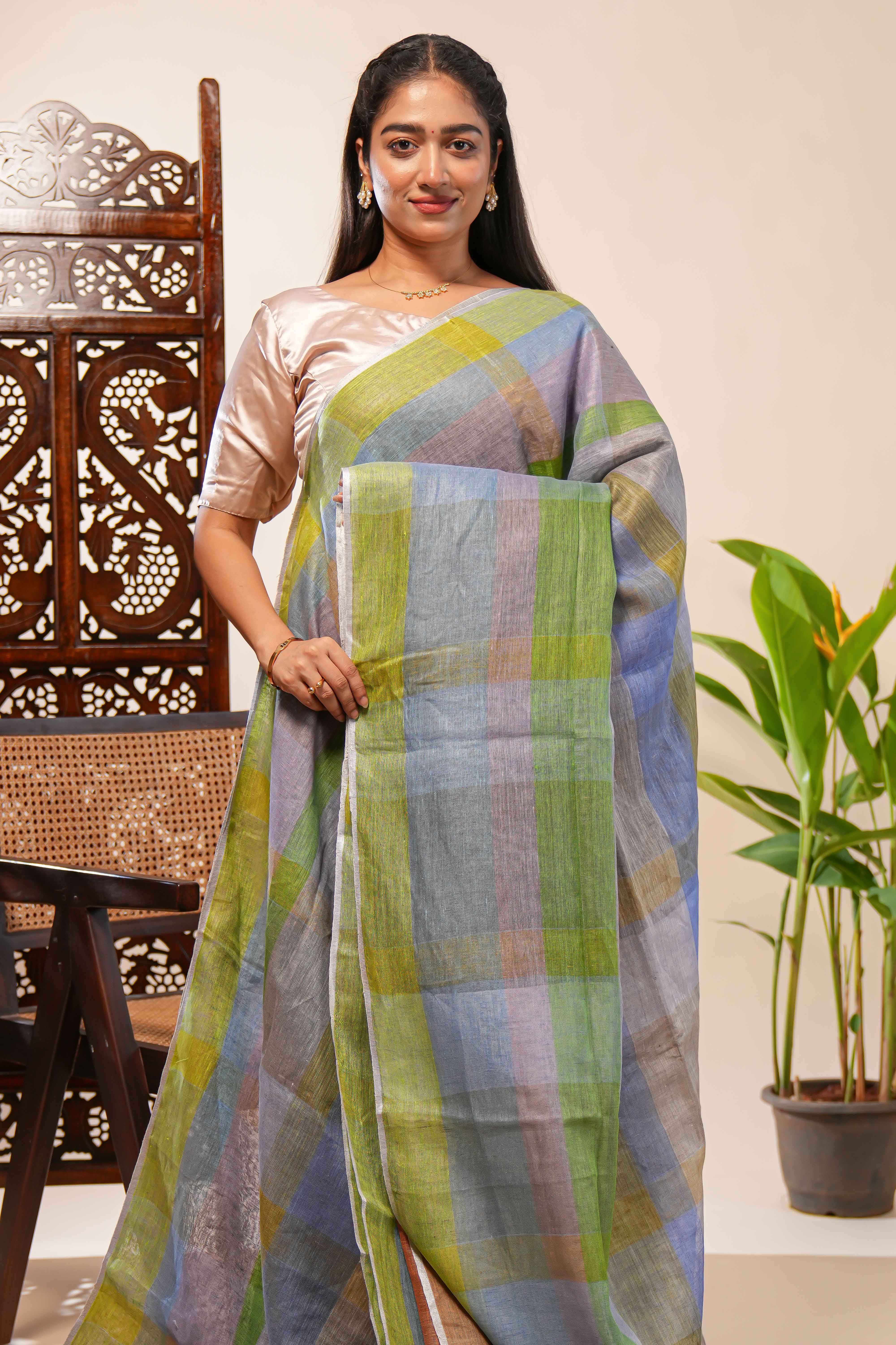 Green done Tones semi tussarall over saree Subtle Stripe and Checked pattern along with Tassels and Contrast Blouse