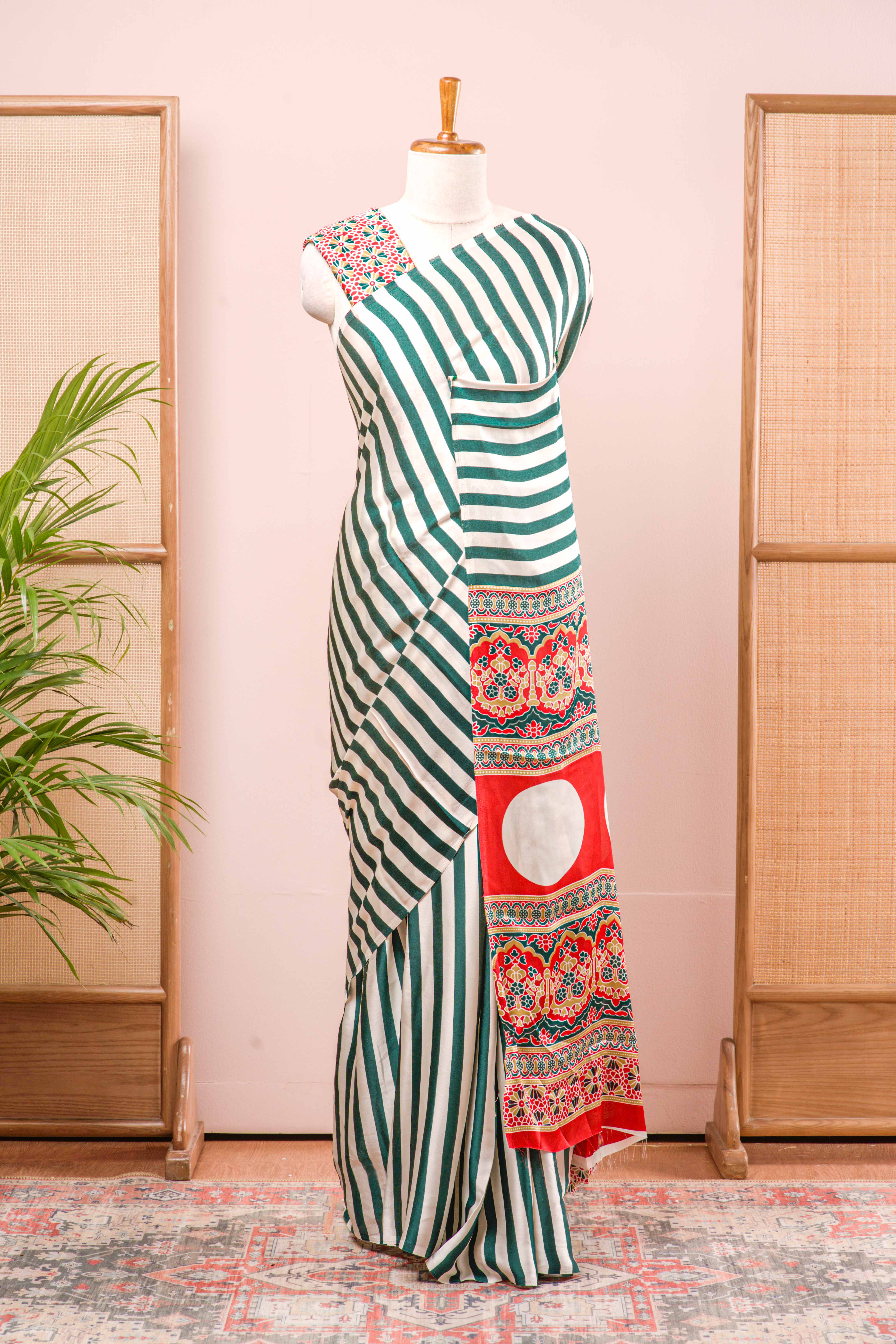 White Modal Silk Saree Detailing Vertical Green Stripes That Add a Sleek and Elegant Touch. Highlighted Contrast Ajrakh Print Pallu Along With Blouse