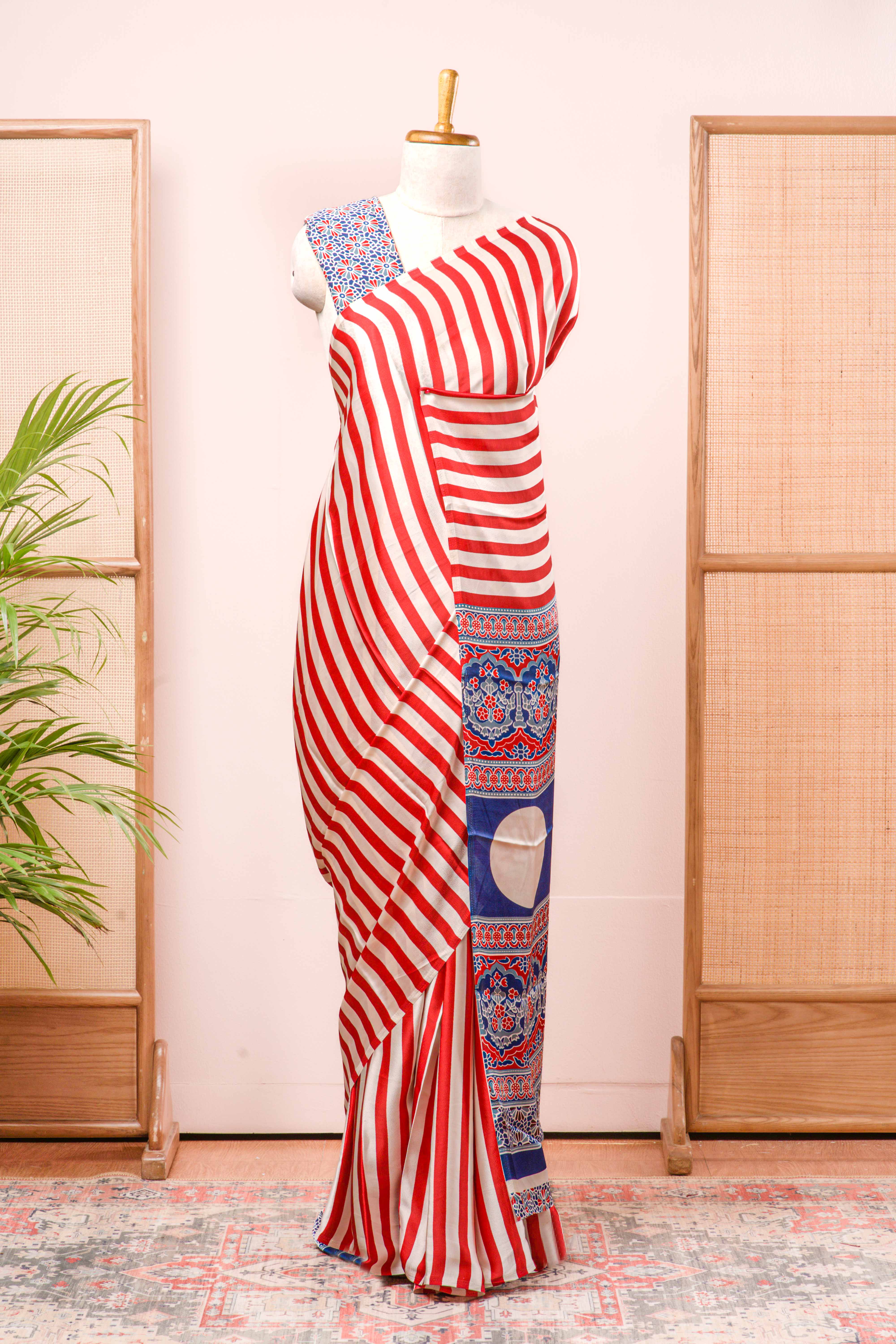 White Modal Silk Saree Body Detailing Contrast Red Vertical Stripes That Add a Sleek and Elegant Touch. The Pallu Are Highlighted Ajrakh Design Along With Blouse