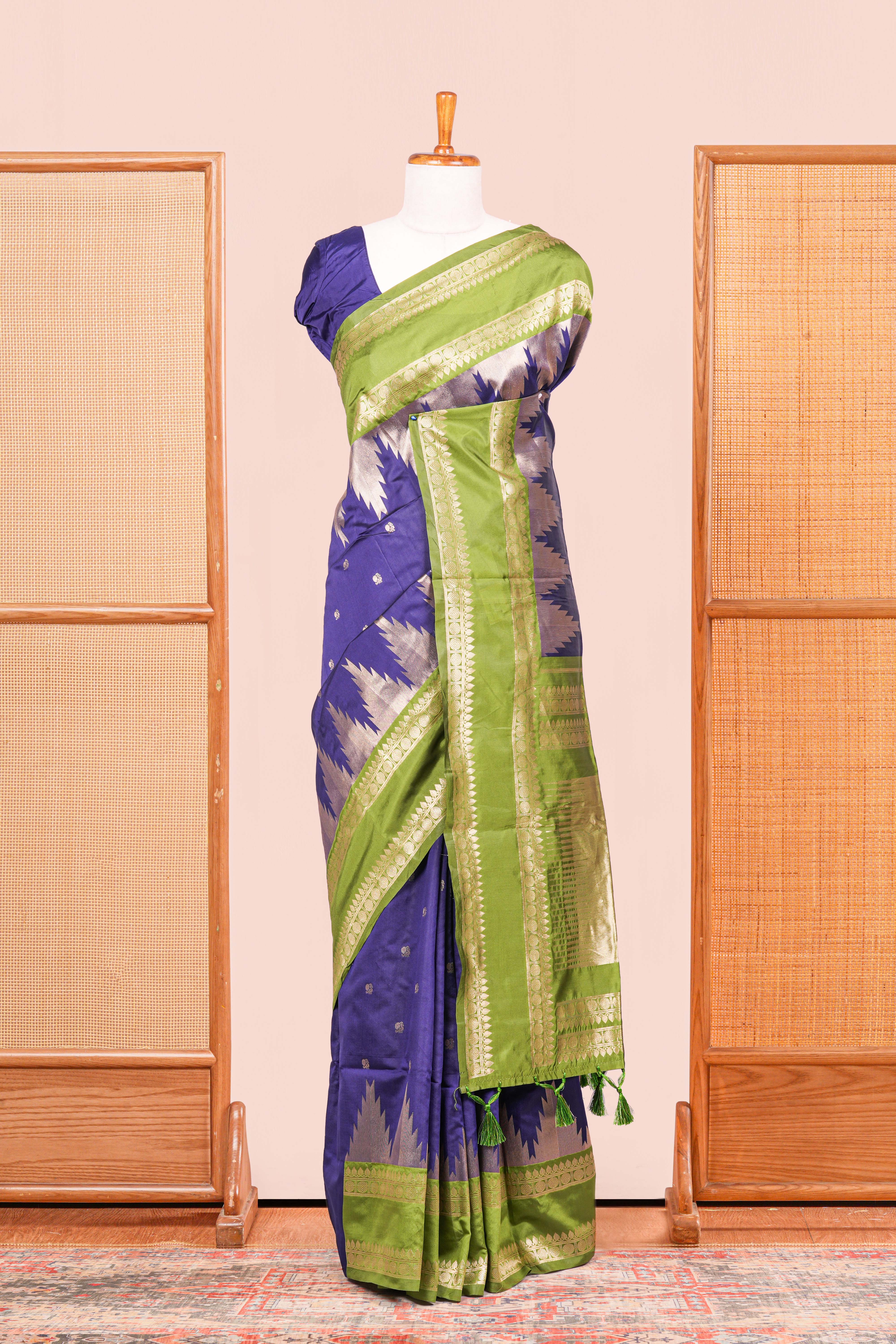 Blue Semi Art Silk Saree Delicate Golden Zari Motifs Along With Thalampoo Zari Woven Across The Body. The Border Is Broad With Intricate FloralZari Weaving Rich Golden Zari Pallu