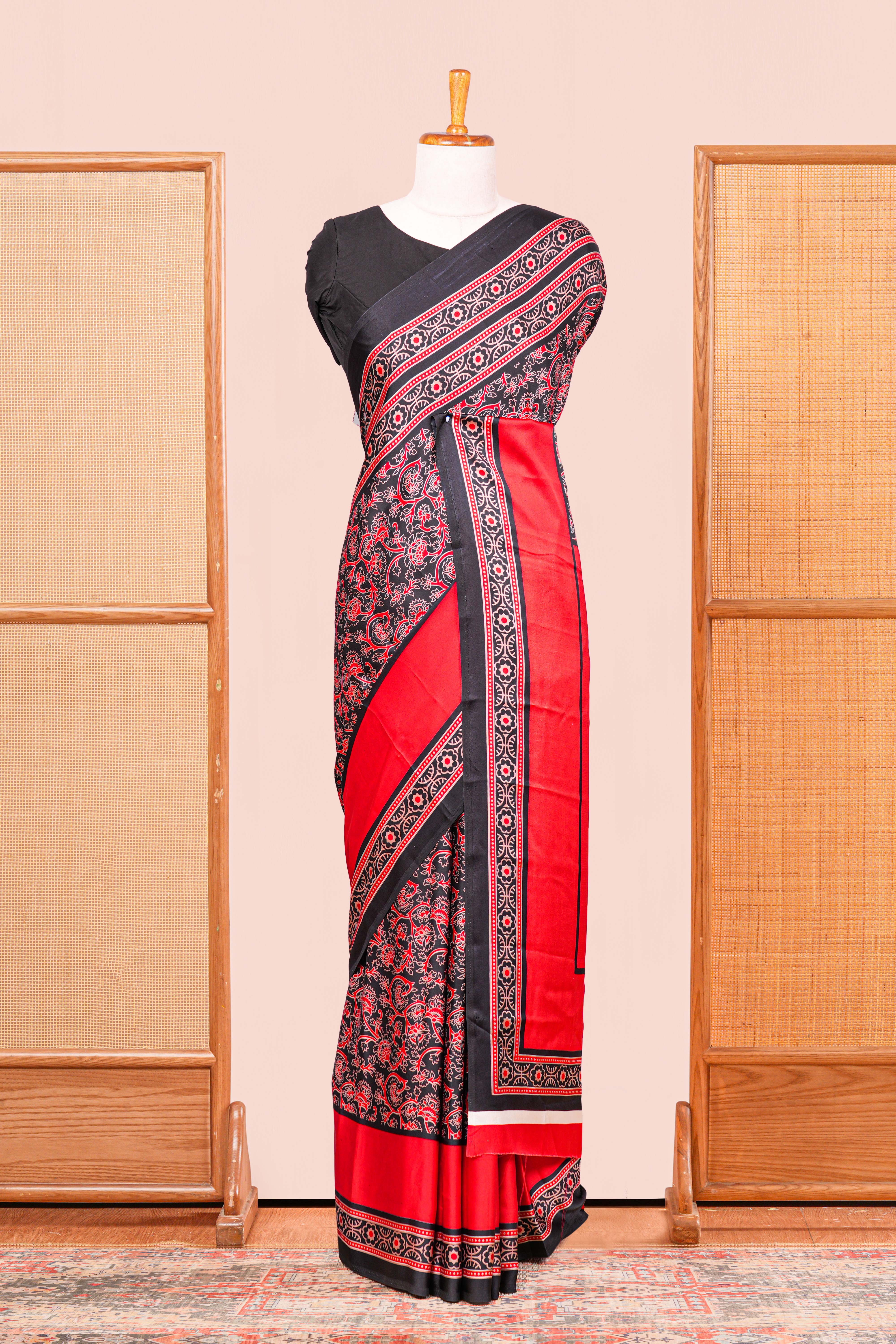 Black Modal Silk Saree The Body Has Ajrakh Design The Pallu Are Highlighted Vibrant Red Colour Along With Blouse