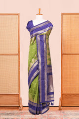 Green Semi Art Silk Saree Delicate Golden Zari Motifs Along With Thalampoo Zari Woven Across The Body. The Border Is Broad With Intricate Floral Zari Weaving Rich Golden Zari Pallu
