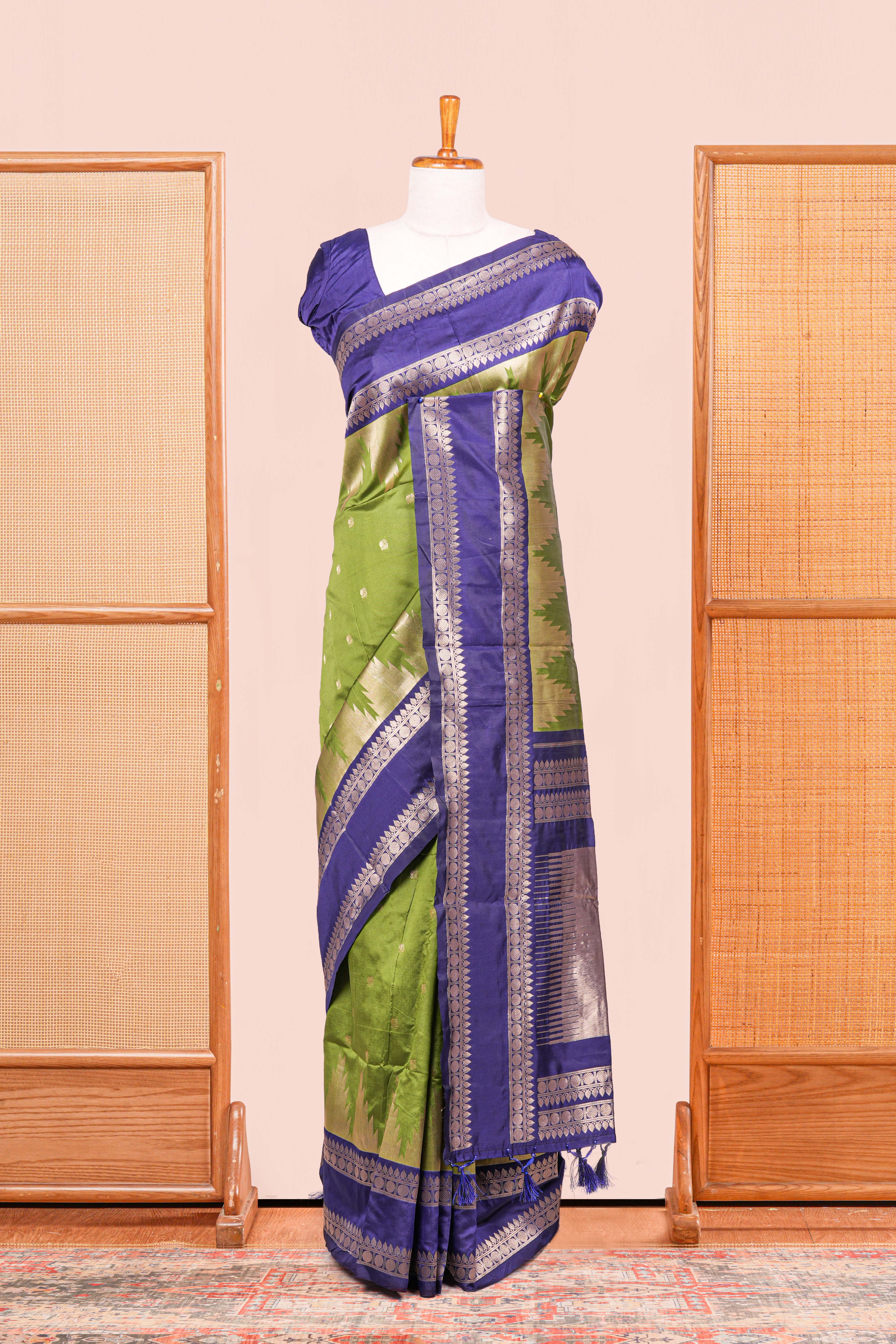 Green Semi Art Silk Saree Delicate Golden Zari Motifs Along With Thalampoo Zari Woven Across The Body. The Border Is Broad With Intricate Floral Zari Weaving Rich Golden Zari Pallu