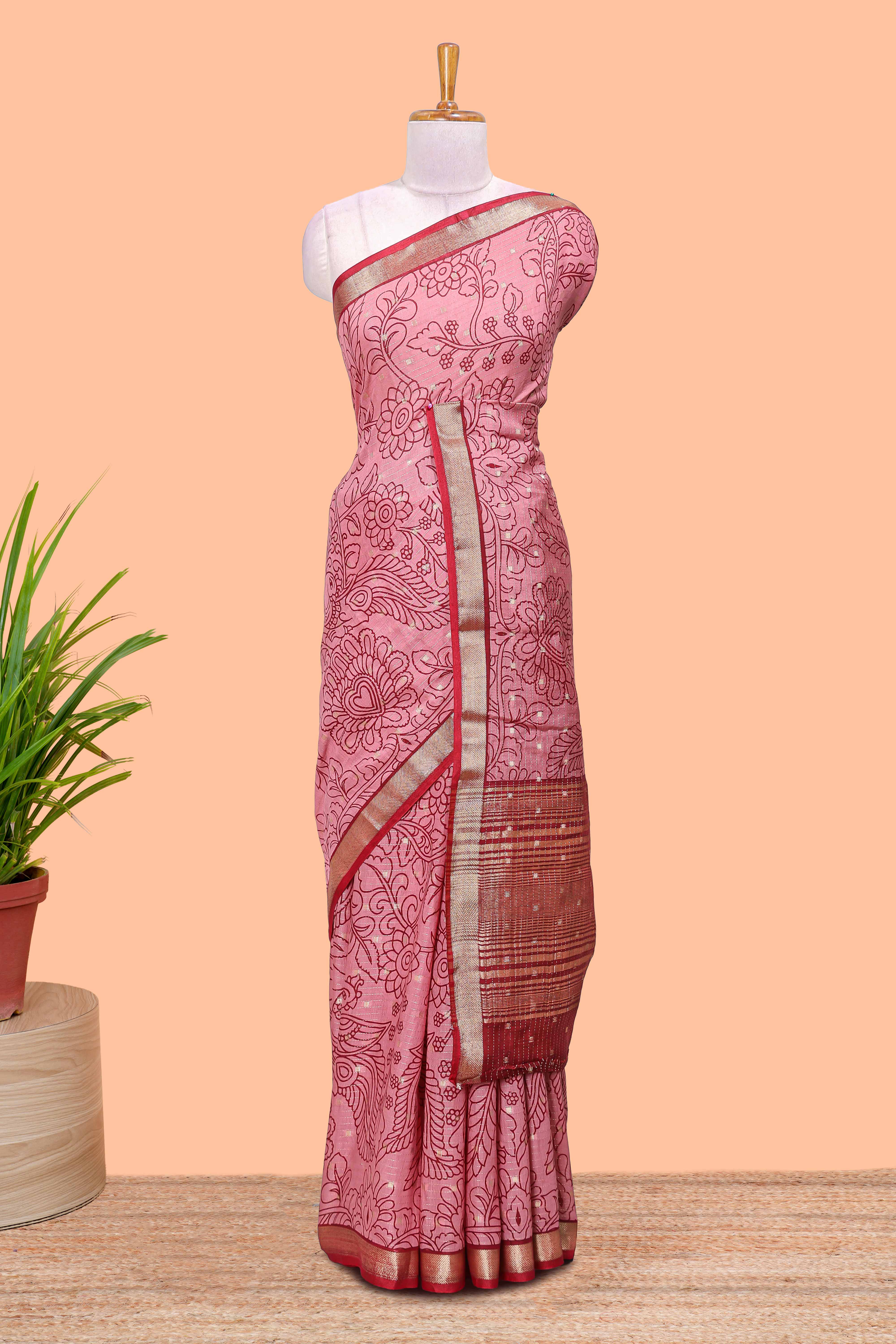 Pink assam silk abstract face print saree with contrast zari border and pallu