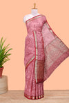 Pink assam silk abstract face print saree with contrast zari border and pallu