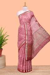 Pink assam silk abstract face print saree with contrast zari border and pallu