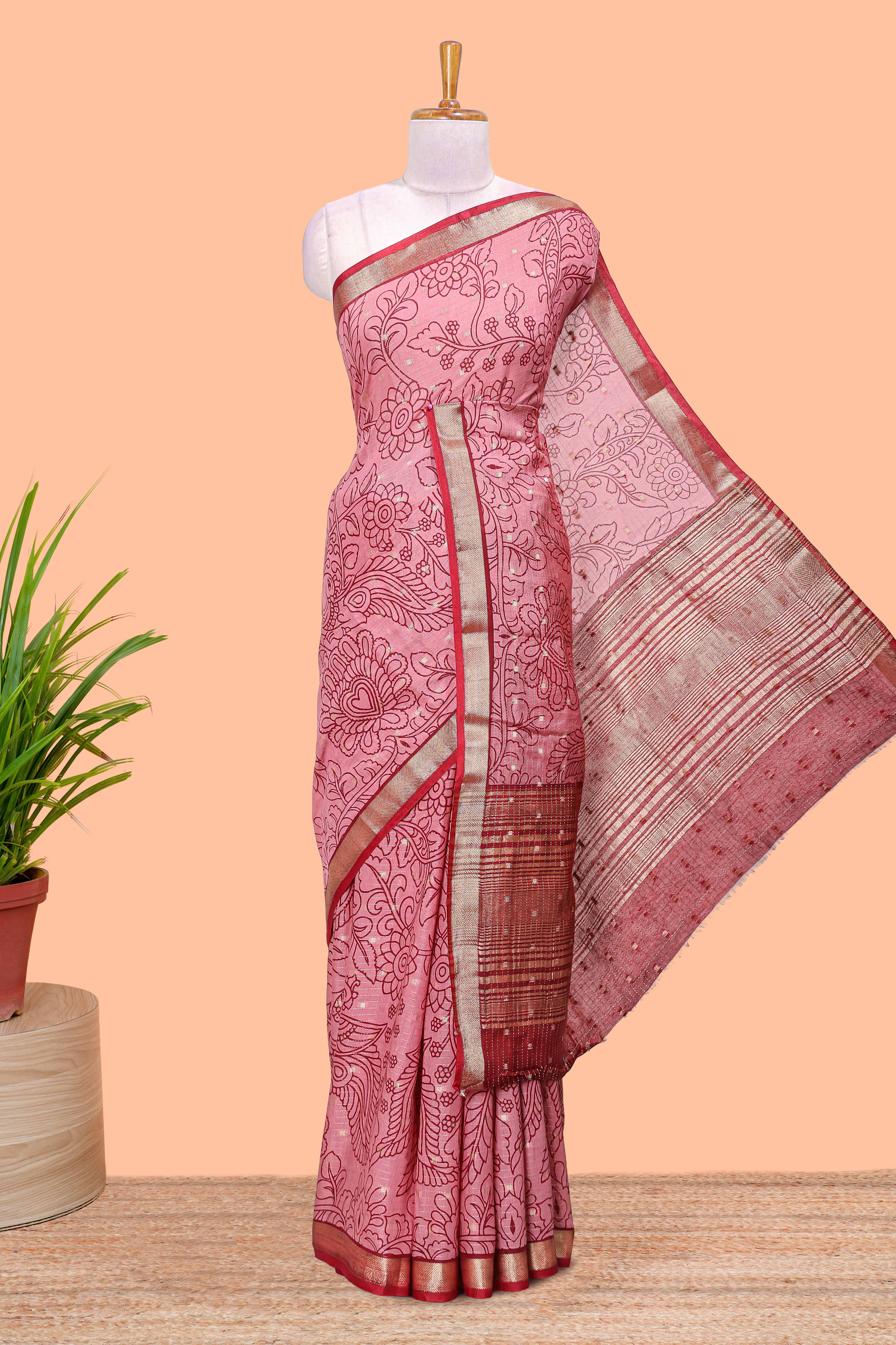 Pink assam silk abstract face print saree with contrast zari border and pallu