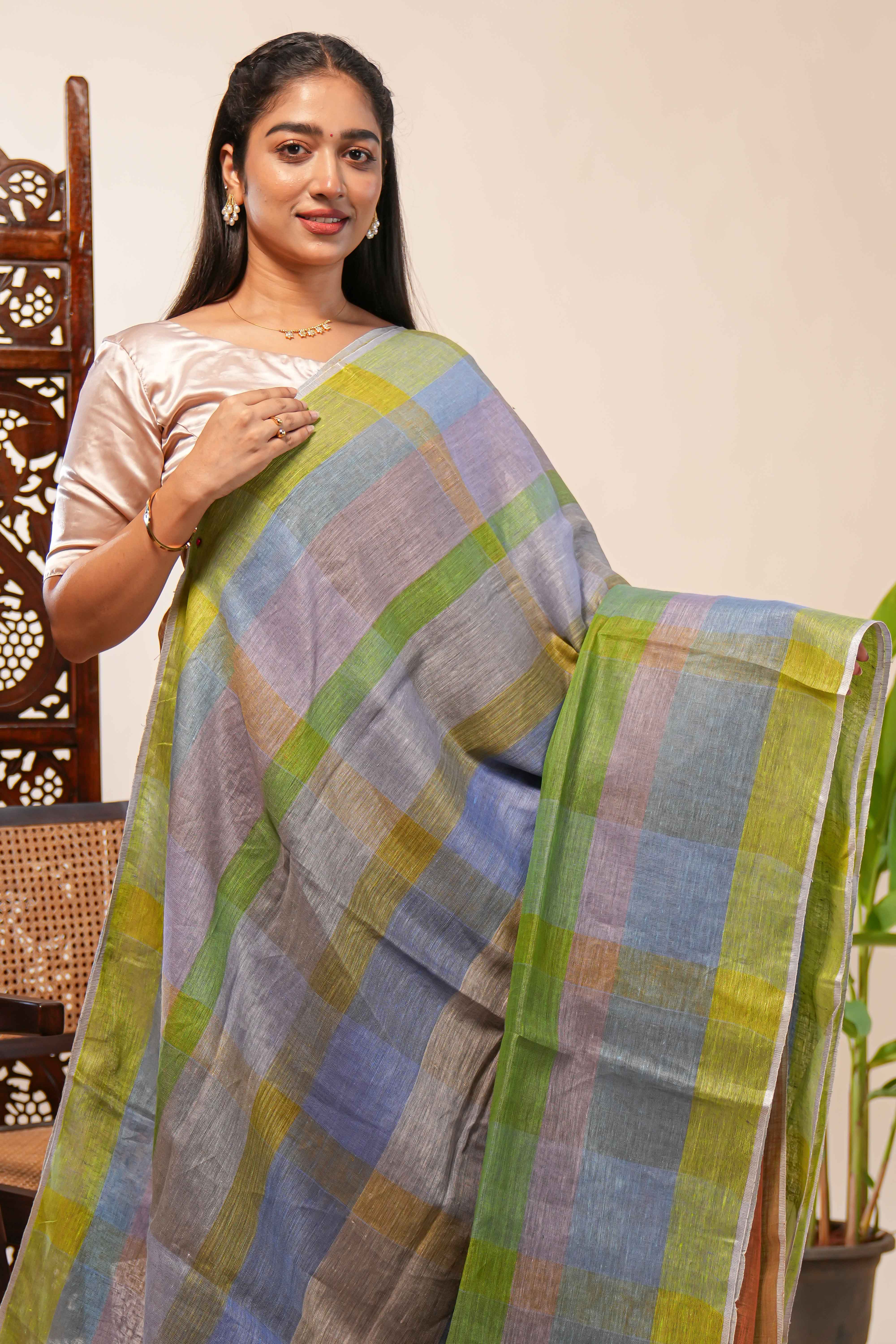 Green done Tones semi tussarall over saree Subtle Stripe and Checked pattern along with Tassels and Contrast Blouse