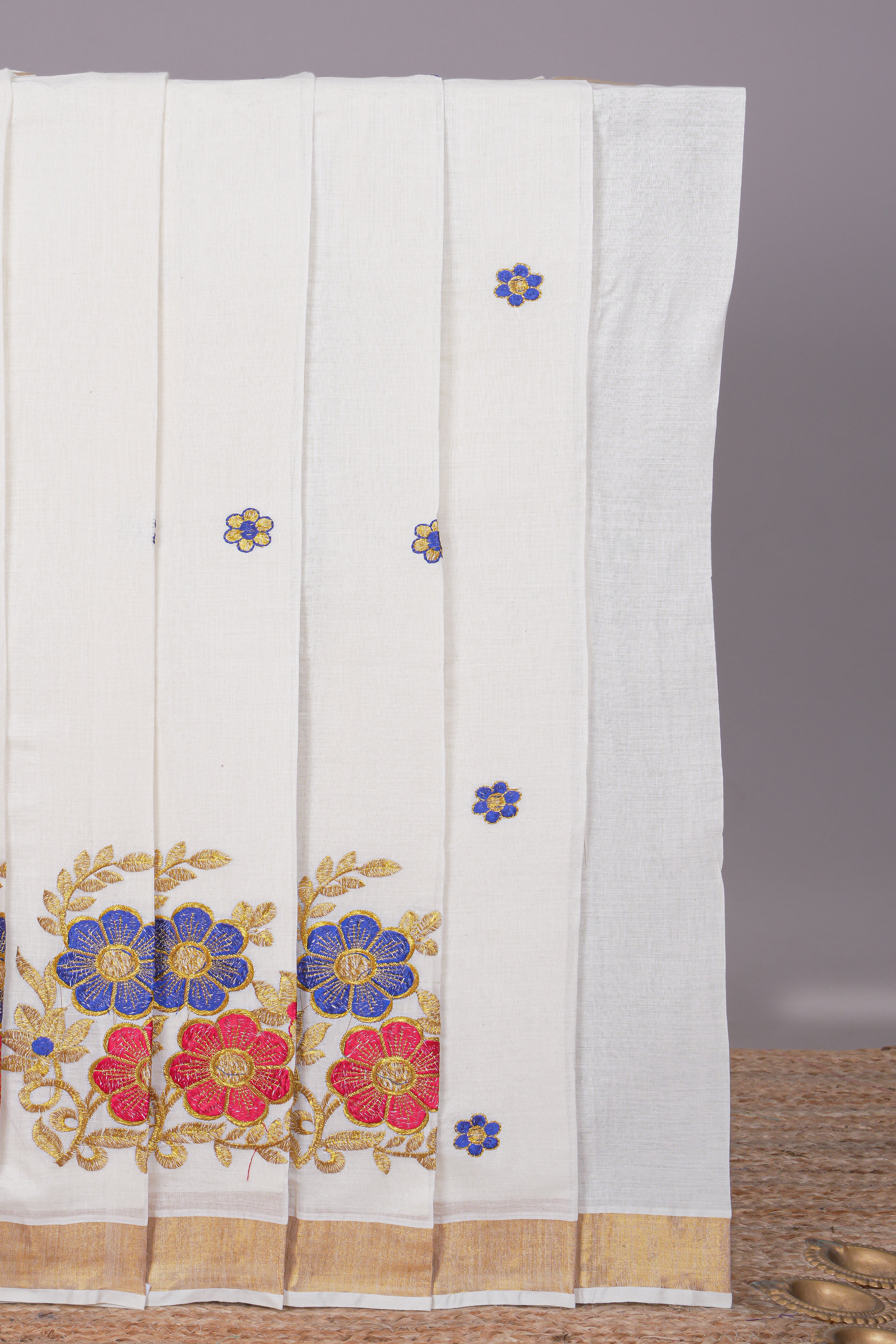 Cream floral motifs design kerala cotton saree with self zari border and matching blouse