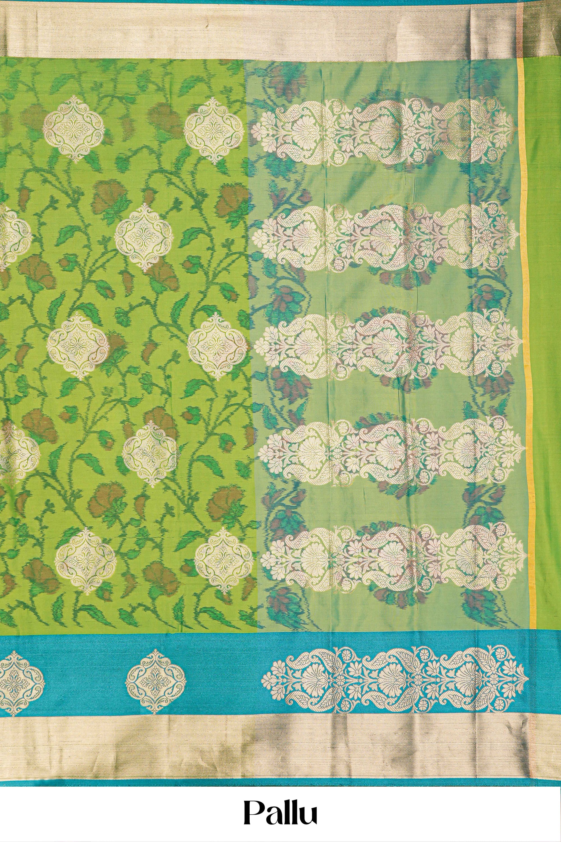 Green floral patterned fabric with a blue border and pallu