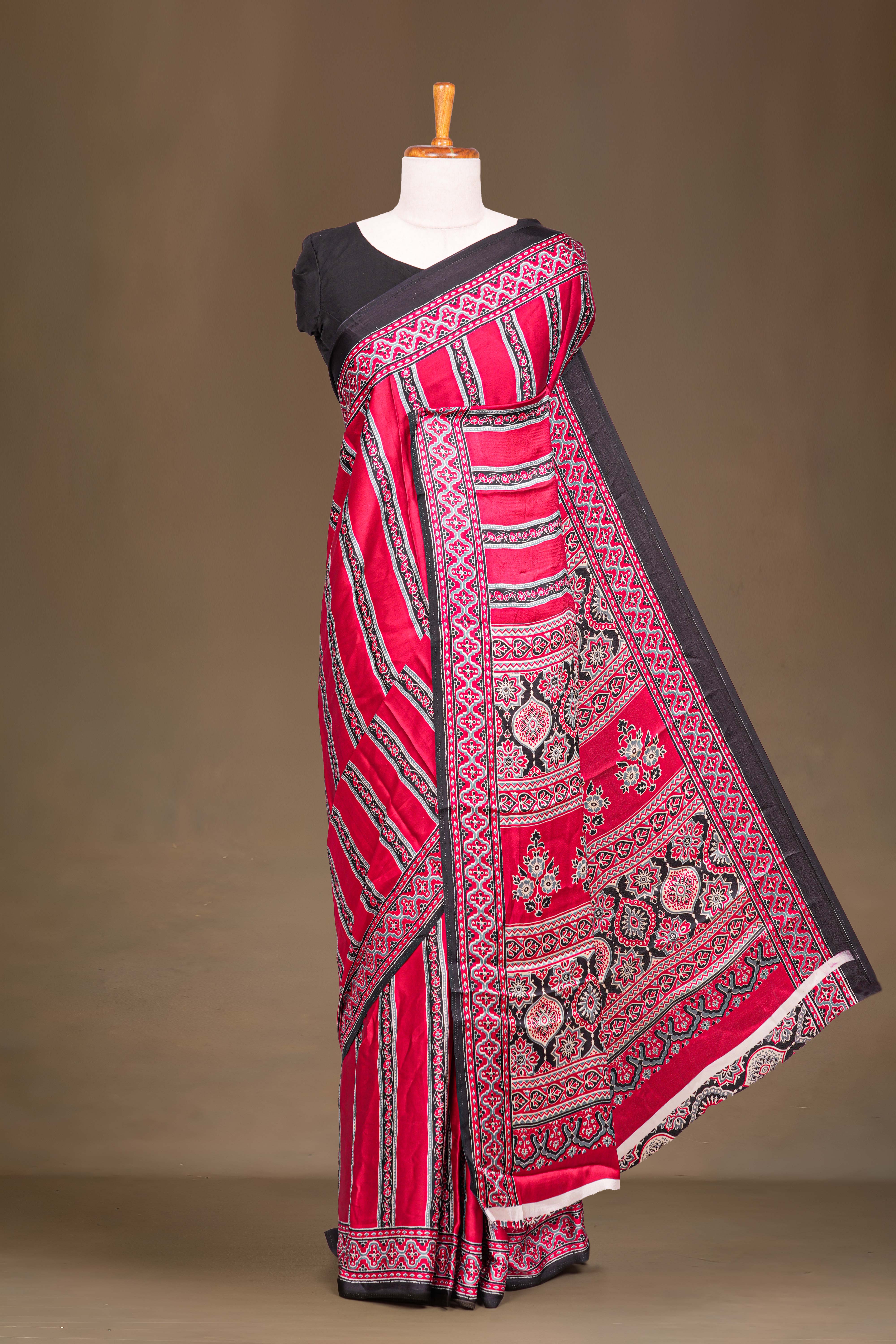 Red Modal Silk Saree The Body Has Ajrakh Design The Pallu Are Highlighted Vibrant Red Printed Along With Ajrakh Print Blouse