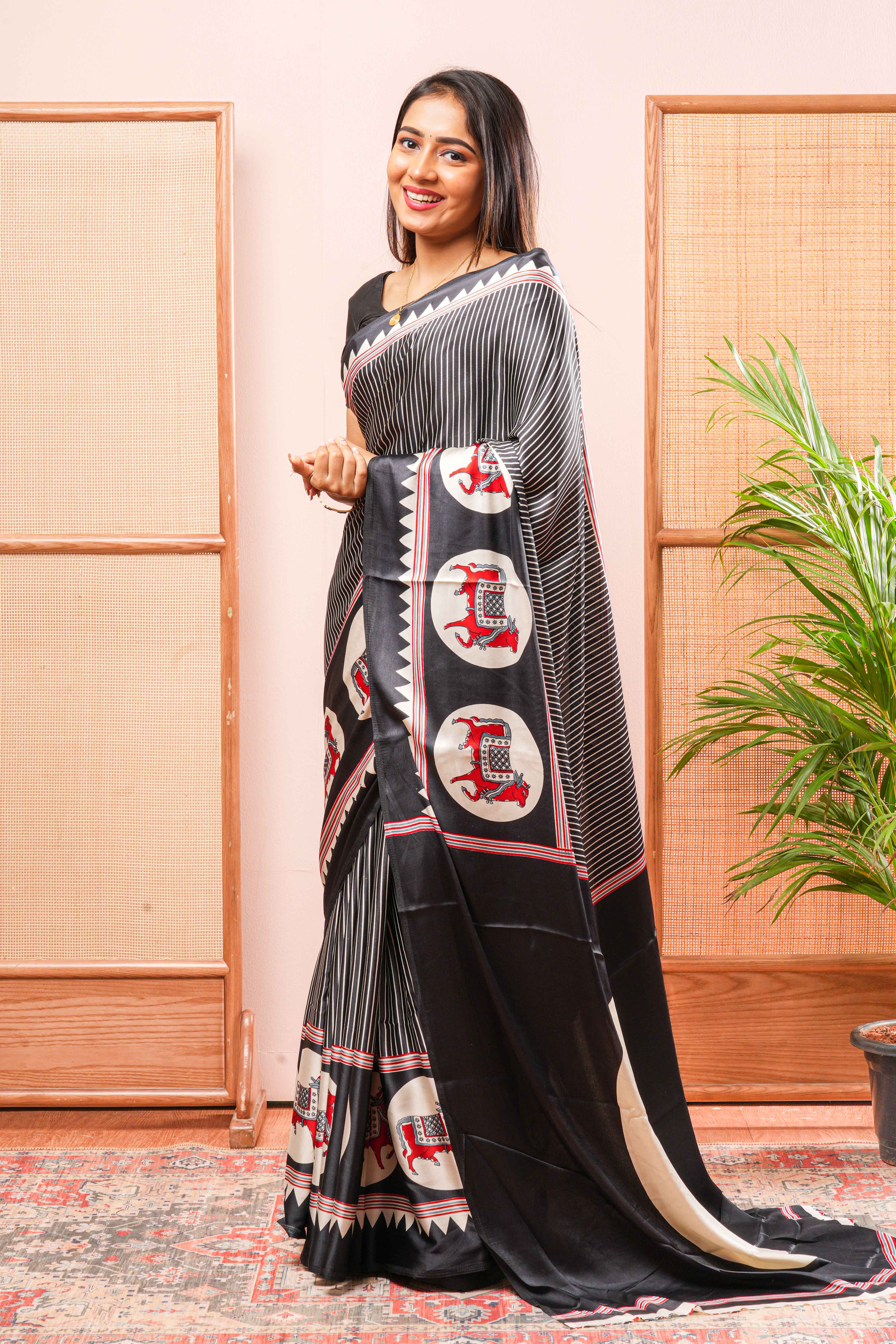 Black Modal Silk SareeThe Body Has Fine Vertical White StripesThe Border Are Highlighted Pichwai Design Contrast Coin Motifs In PalluAlong With AjrakhPrinted Blouse