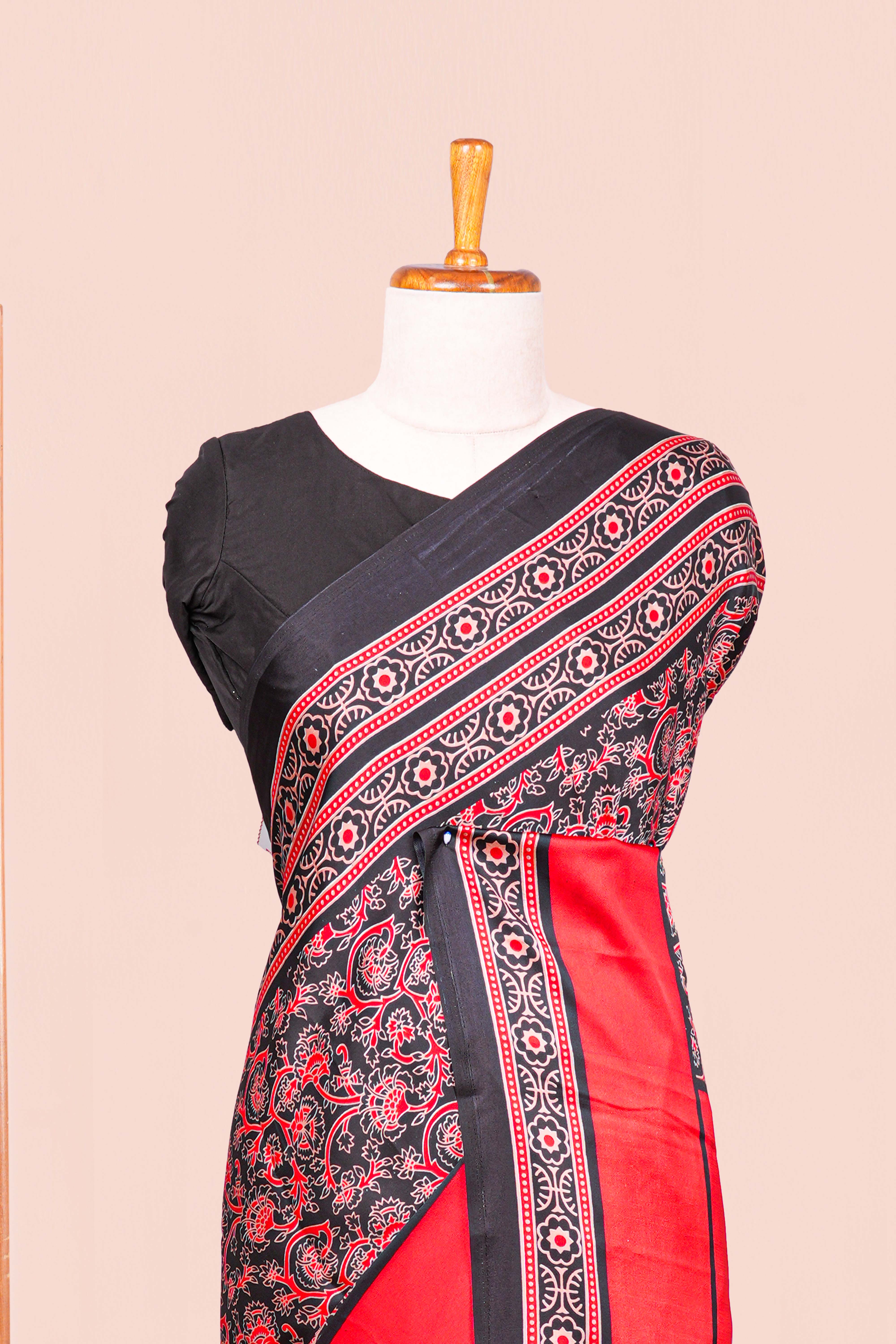Black Modal Silk Saree The Body Has Ajrakh Design The Pallu Are Highlighted Vibrant Red Colour Along With Blouse