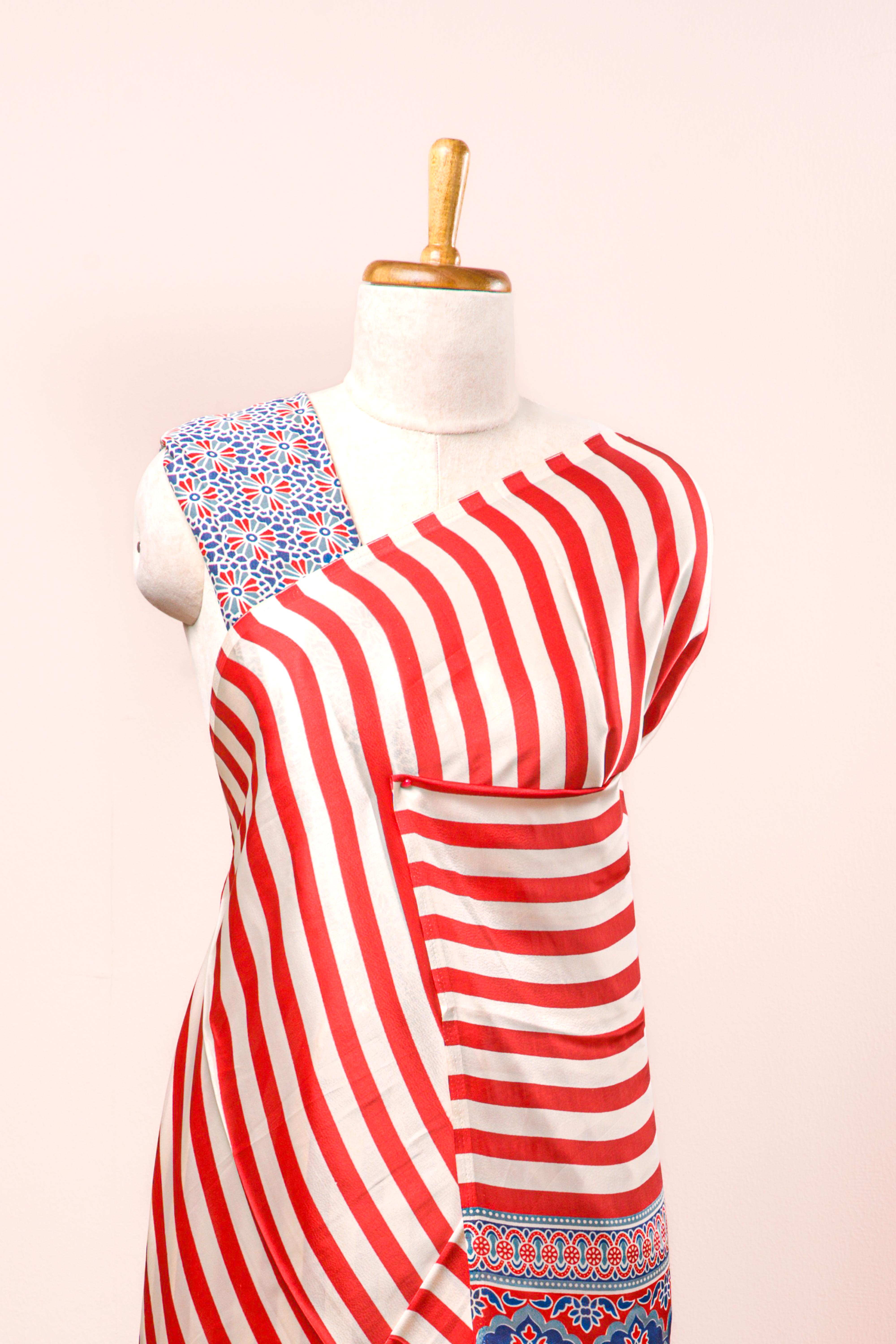 White Modal Silk Saree Body Detailing Contrast Red Vertical Stripes That Add a Sleek and Elegant Touch. The Pallu Are Highlighted Ajrakh Design Along With Blouse