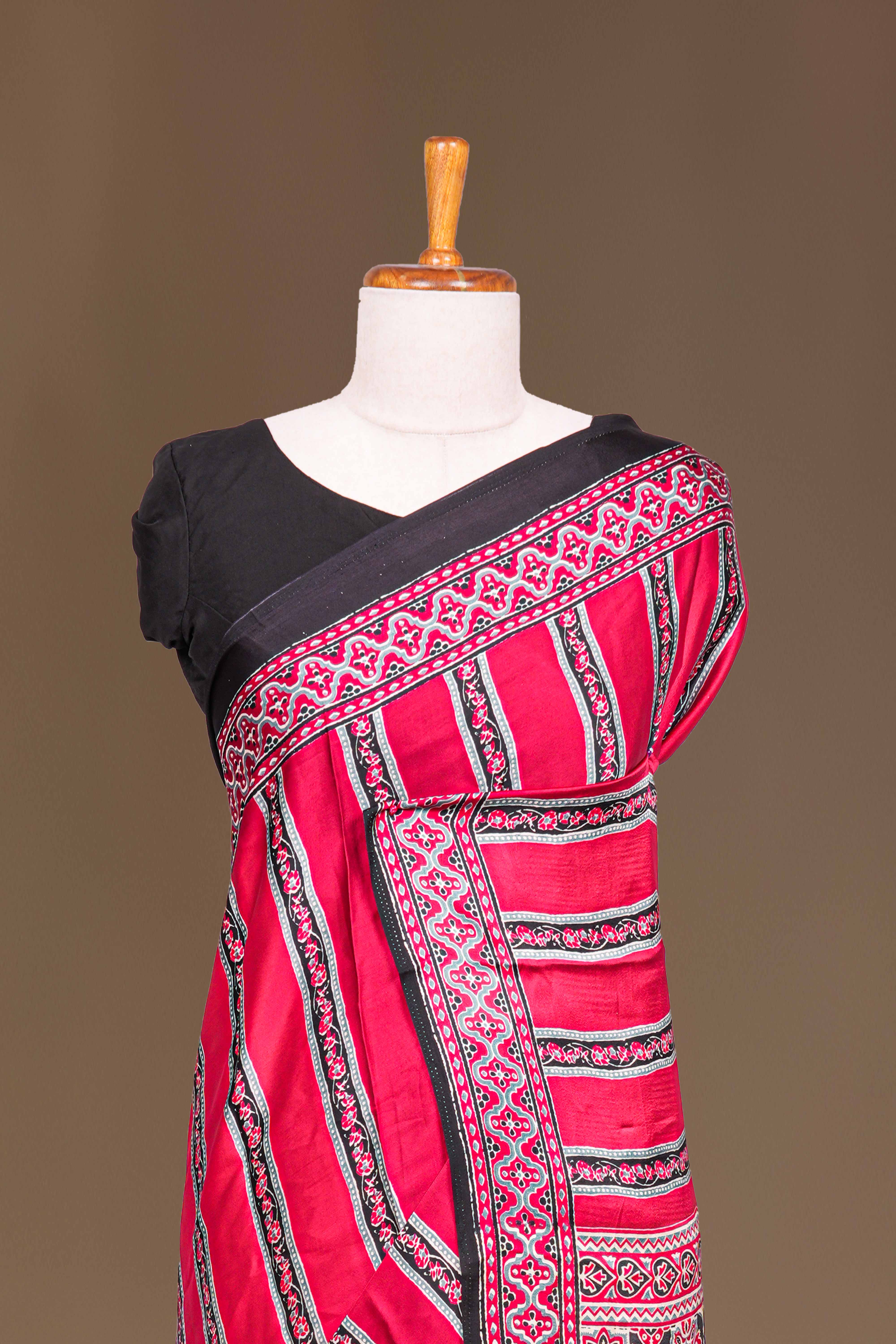 Red Modal Silk Saree The Body Has Ajrakh Design The Pallu Are Highlighted Vibrant Red Printed Along With Ajrakh Print Blouse