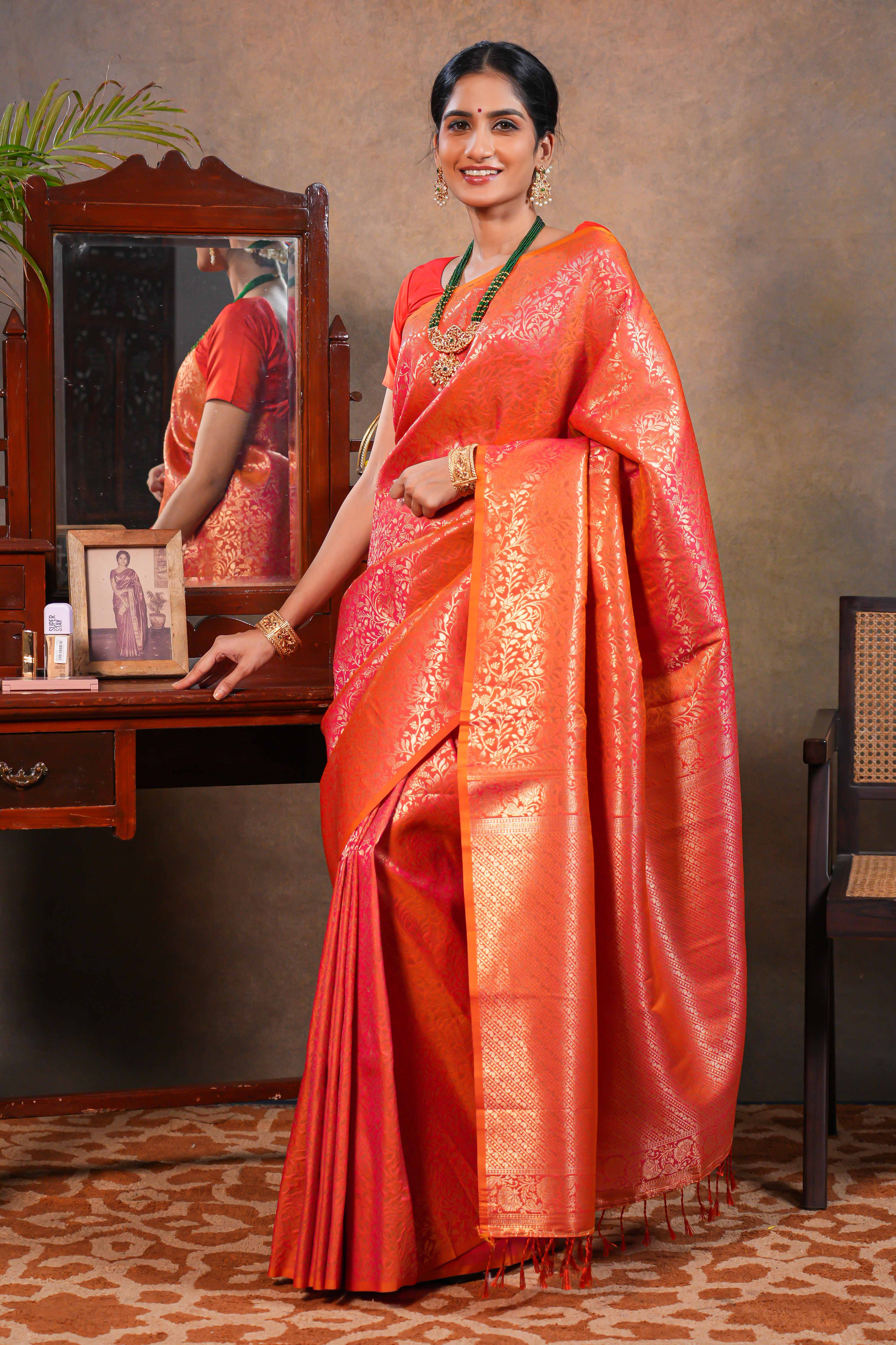 Orange colour Semi Soft Silk Saree with intricate gold zari floral vine weaving patterns and Rich zari woven pallu with Matching blouse