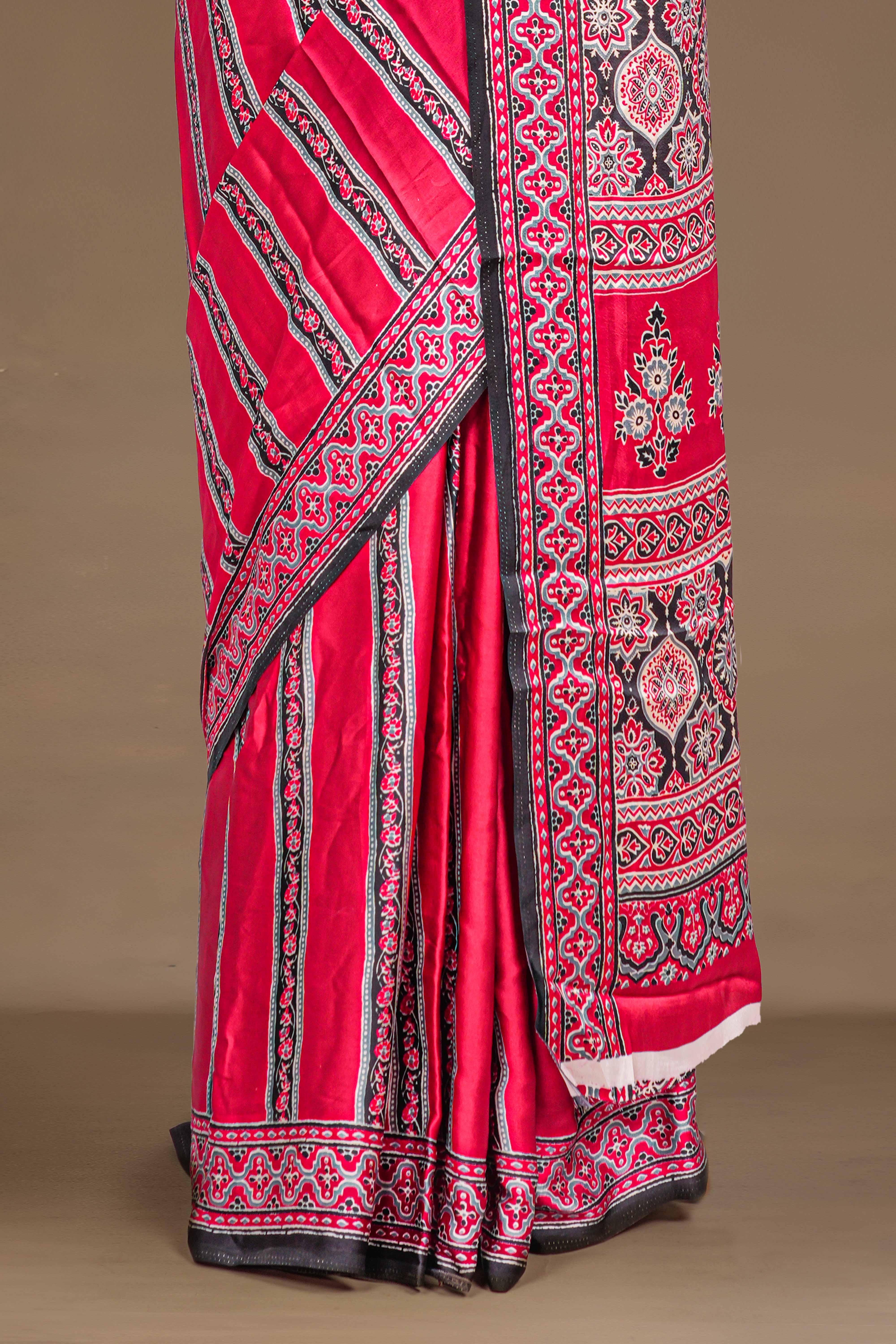 Red Modal Silk Saree The Body Has Ajrakh Design The Pallu Are Highlighted Vibrant Red Printed Along With Ajrakh Print Blouse