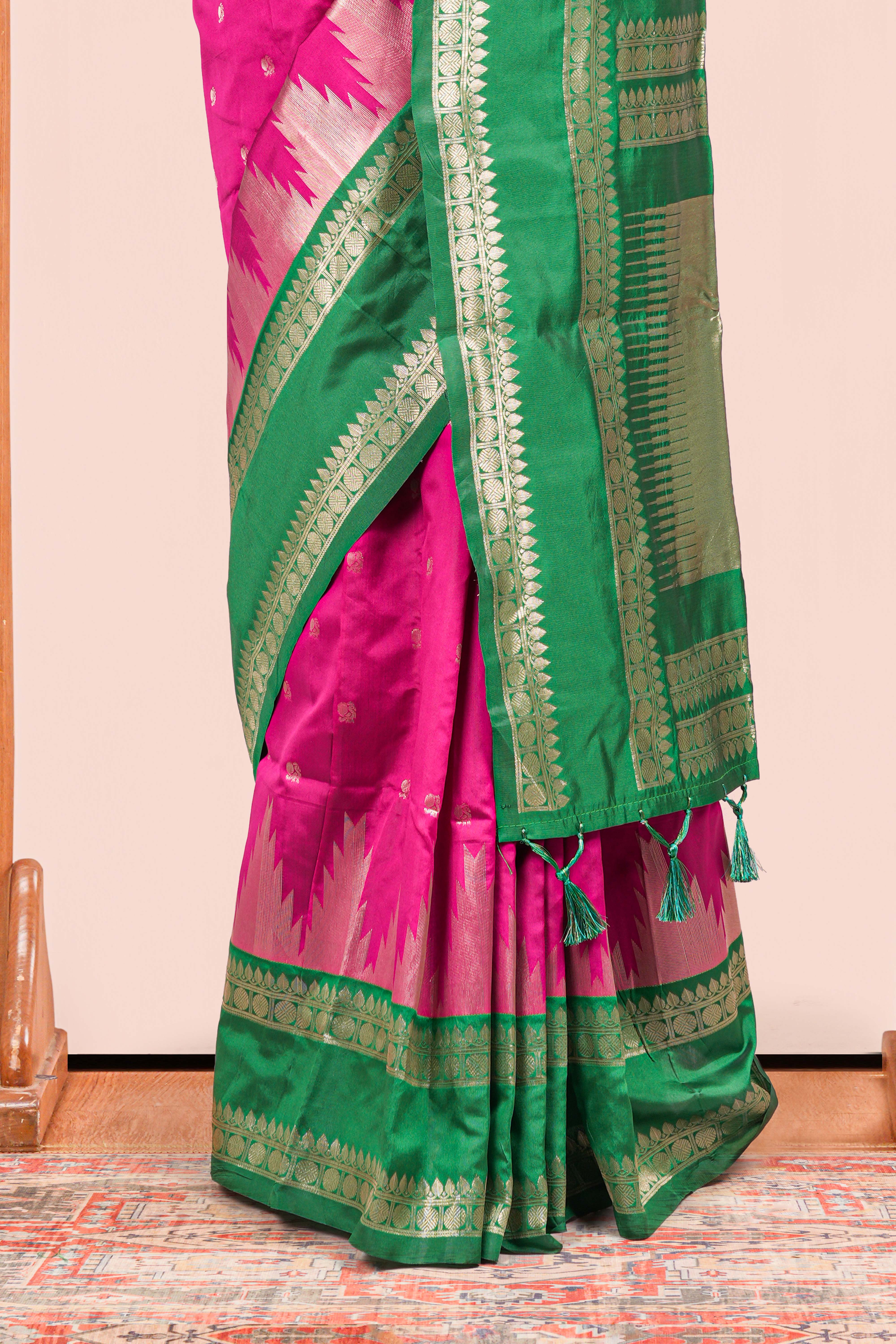 Pink Semi Art Silk Saree Delicate Golden Zari Motifs Along With Thalampoo Zari Woven Across The Body. The Border Is Broad With Intricate Floral Zari Weaving Rich Golden Zari Pallu