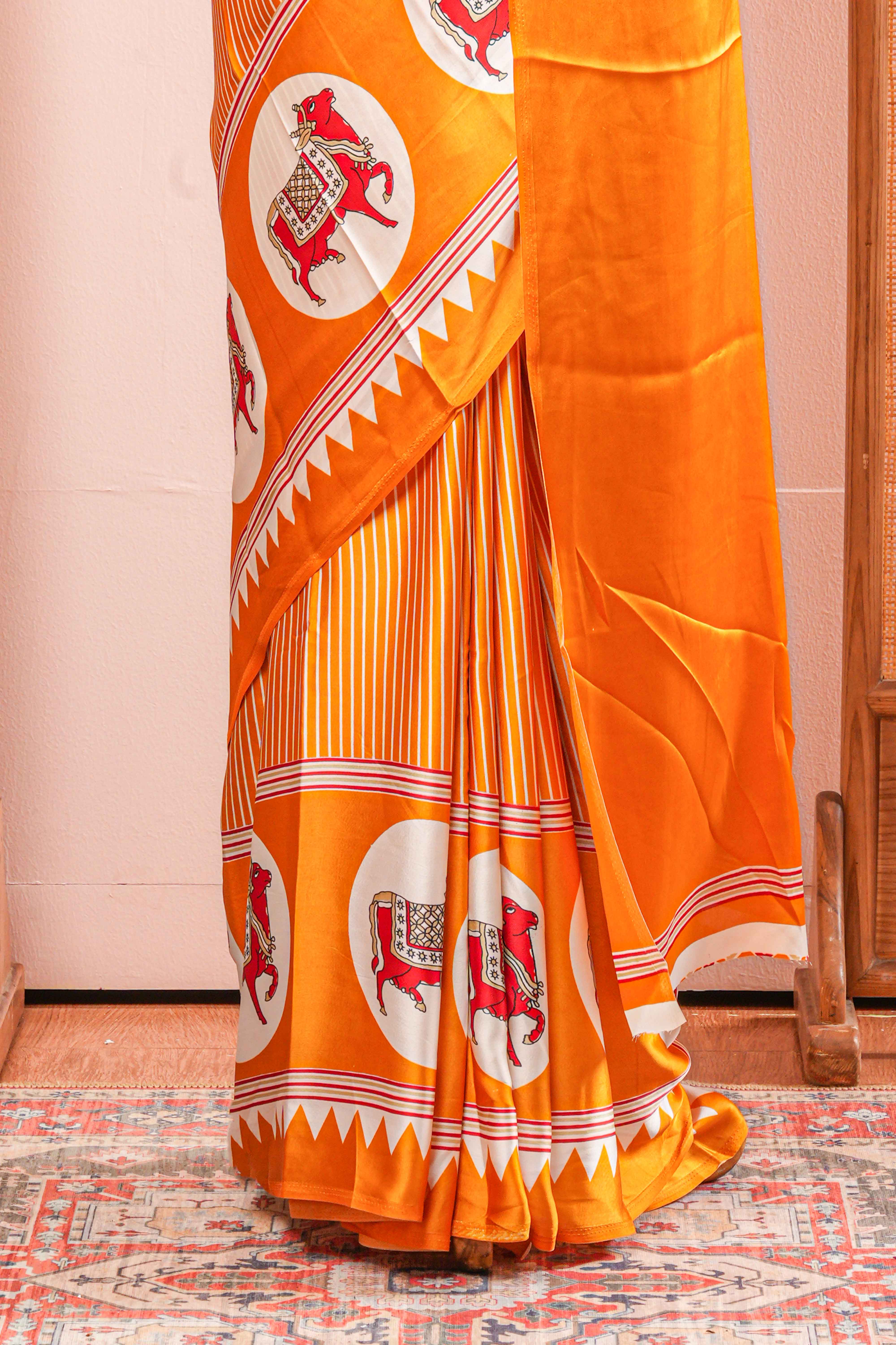 Vibrant Yellow Modal Silk Saree The Body Has Fine Vertical White Stripes The Border Are Highlighted Pichwai Design Along With Ajrakh Printed Blouse