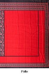 Black Modal Silk Saree The Body Has Ajrakh Design The Pallu Are Highlighted Vibrant Red Colour Along With Blouse