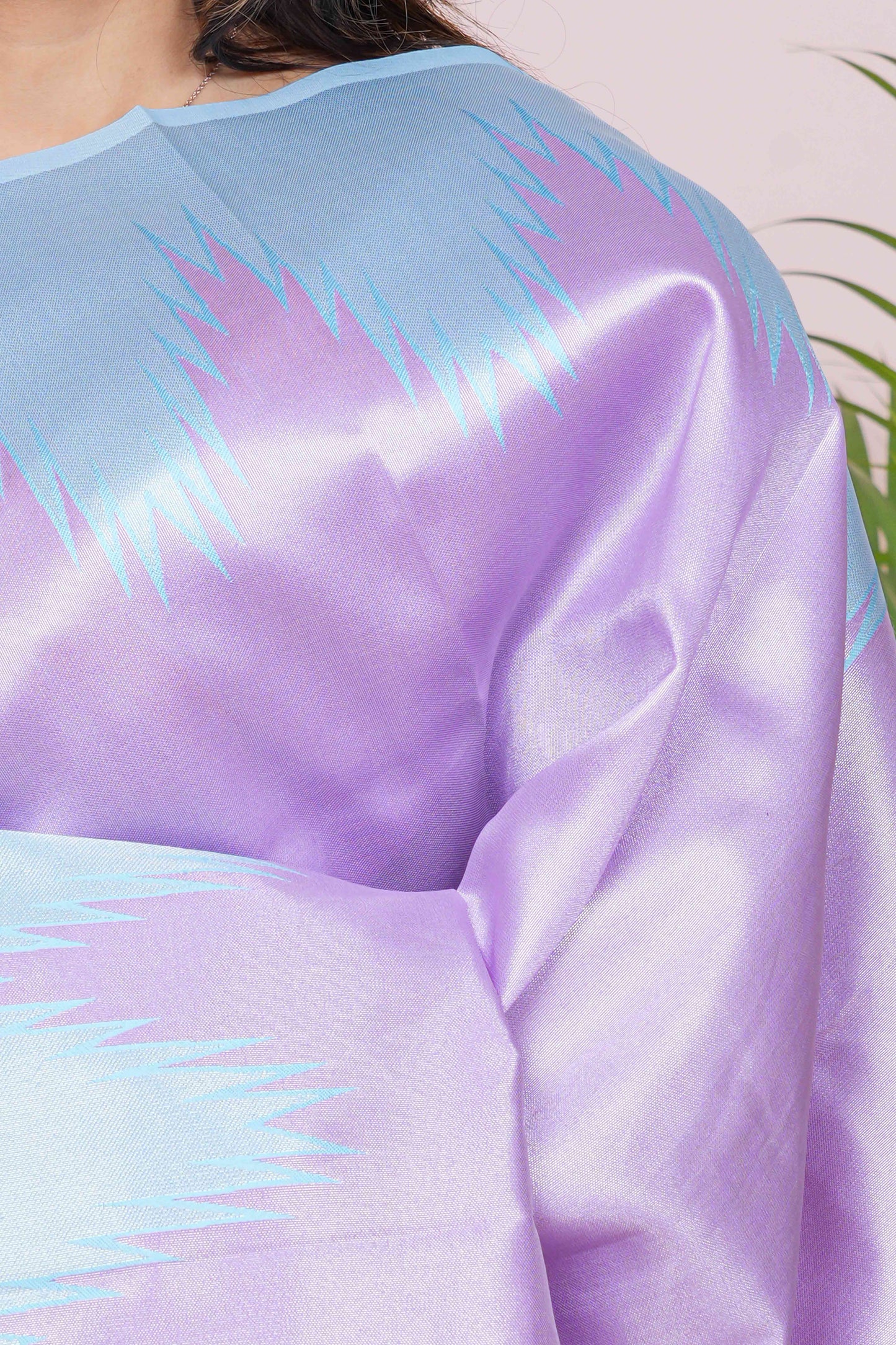 Close-up of a person wearing a pastel-colored garment with a gradient effect.
