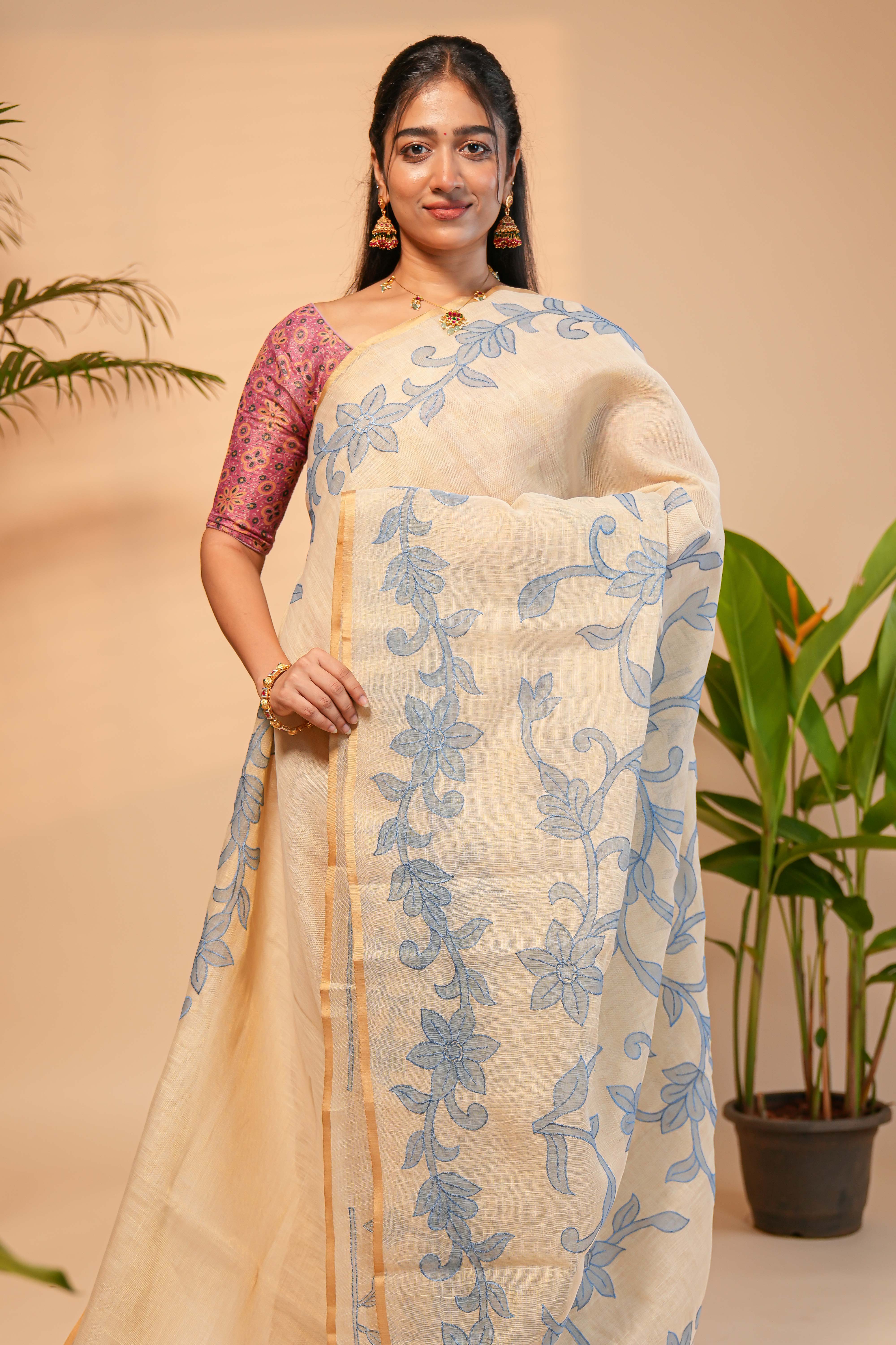 Cream floral design linen cotton saree with self zari border and matching printed blouse