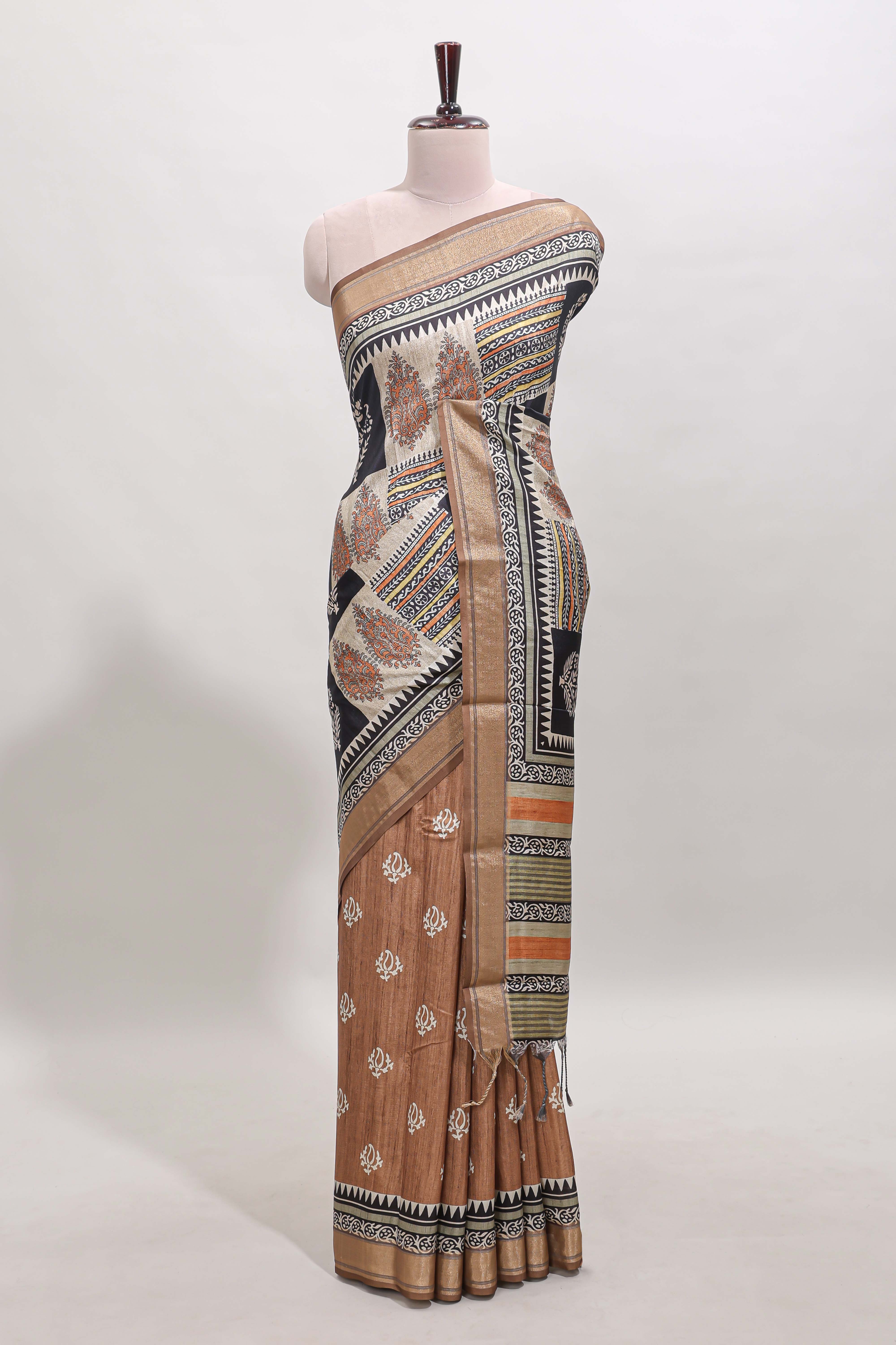 Elegant Tussar Saree with an earthy brown body ethnic prints intricate borders and tassel finished pallu along with contrast blouse