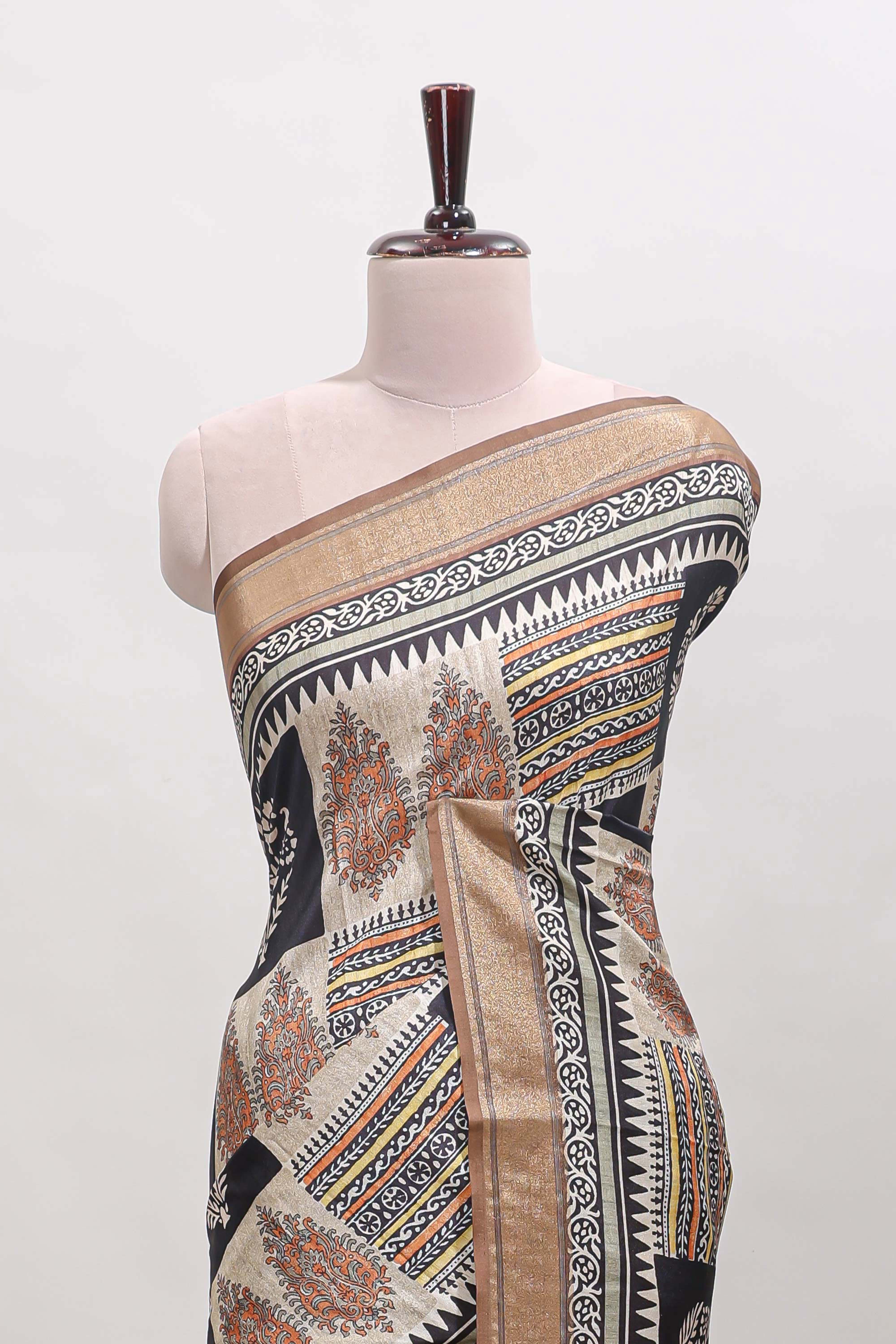 Elegant Tussar Saree with an earthy brown body ethnic prints intricate borders and tassel finished pallu along with contrast blouse
