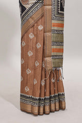 Elegant Tussar Saree with an earthy brown body ethnic prints intricate borders and tassel finished pallu along with contrast blouse
