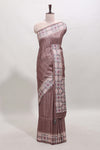 Tussar Silk Saree with a textured mauve body geometric woven border and a designer pallu with tassel along with blouse