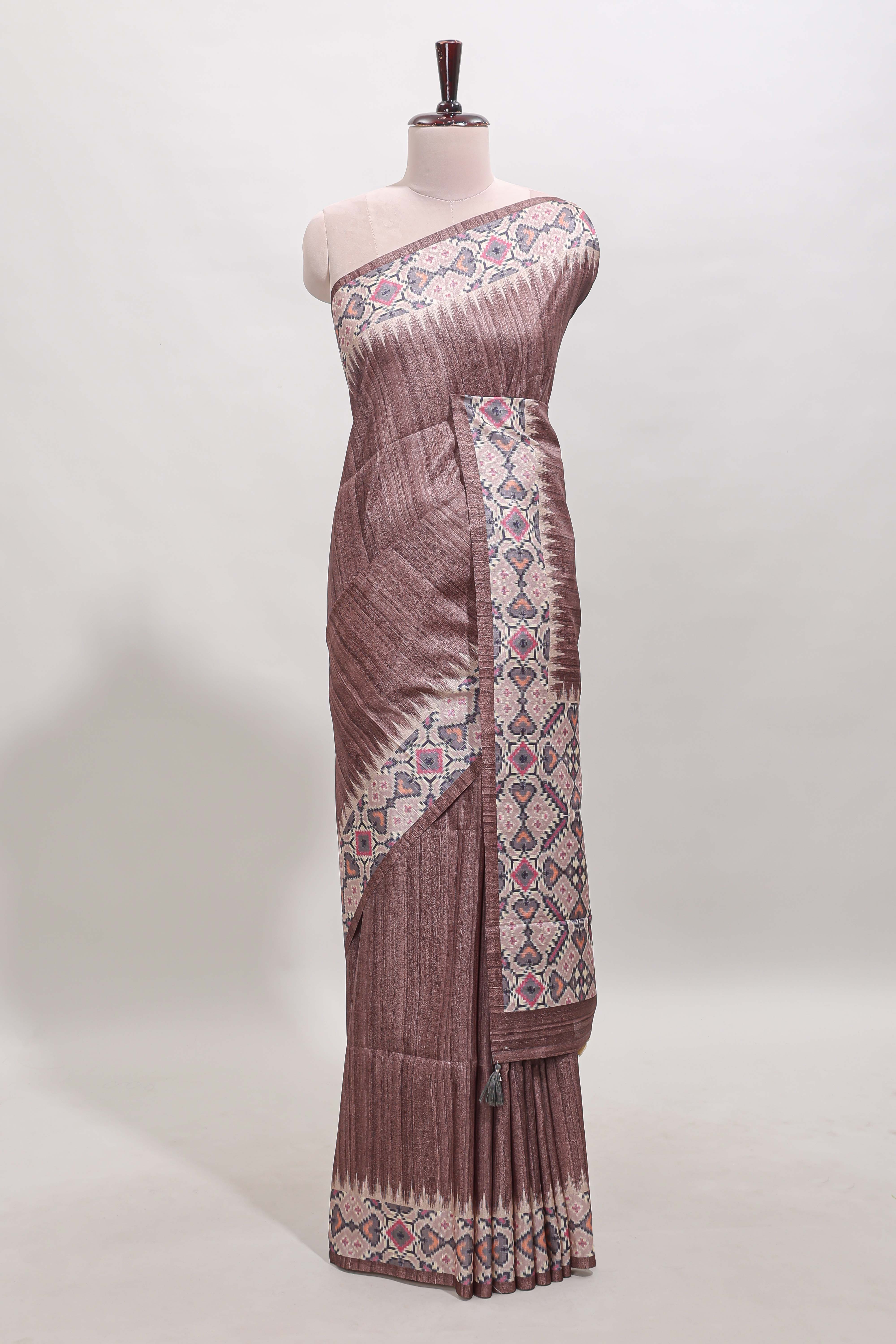 Tussar Silk Saree with a textured mauve body geometric woven border and a designer pallu with tassel along with blouse