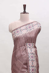 Tussar Silk Saree with a textured mauve body geometric woven border and a designer pallu with tassel along with blouse
