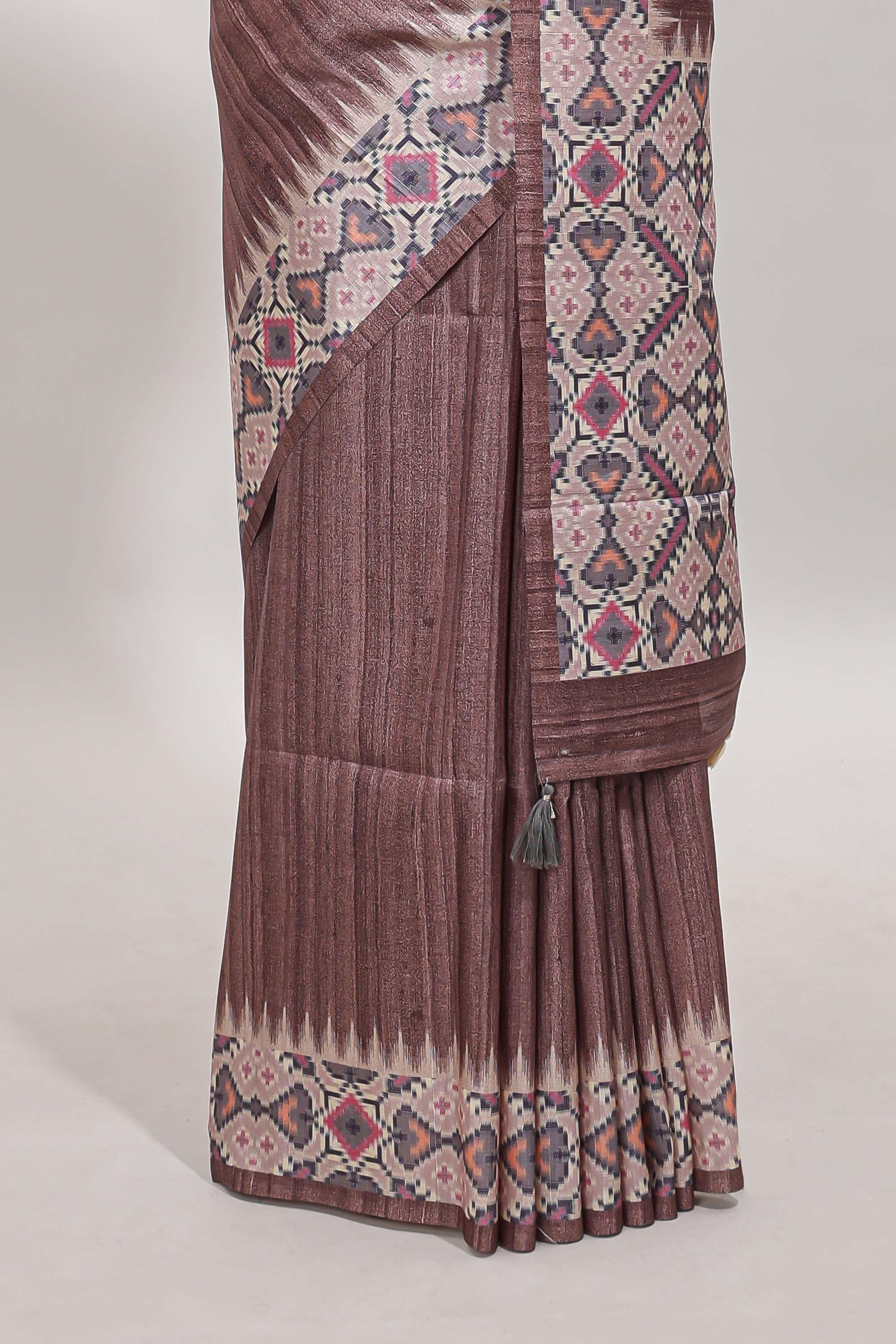 Tussar Silk Saree with a textured mauve body geometric woven border and a designer pallu with tassel along with blouse