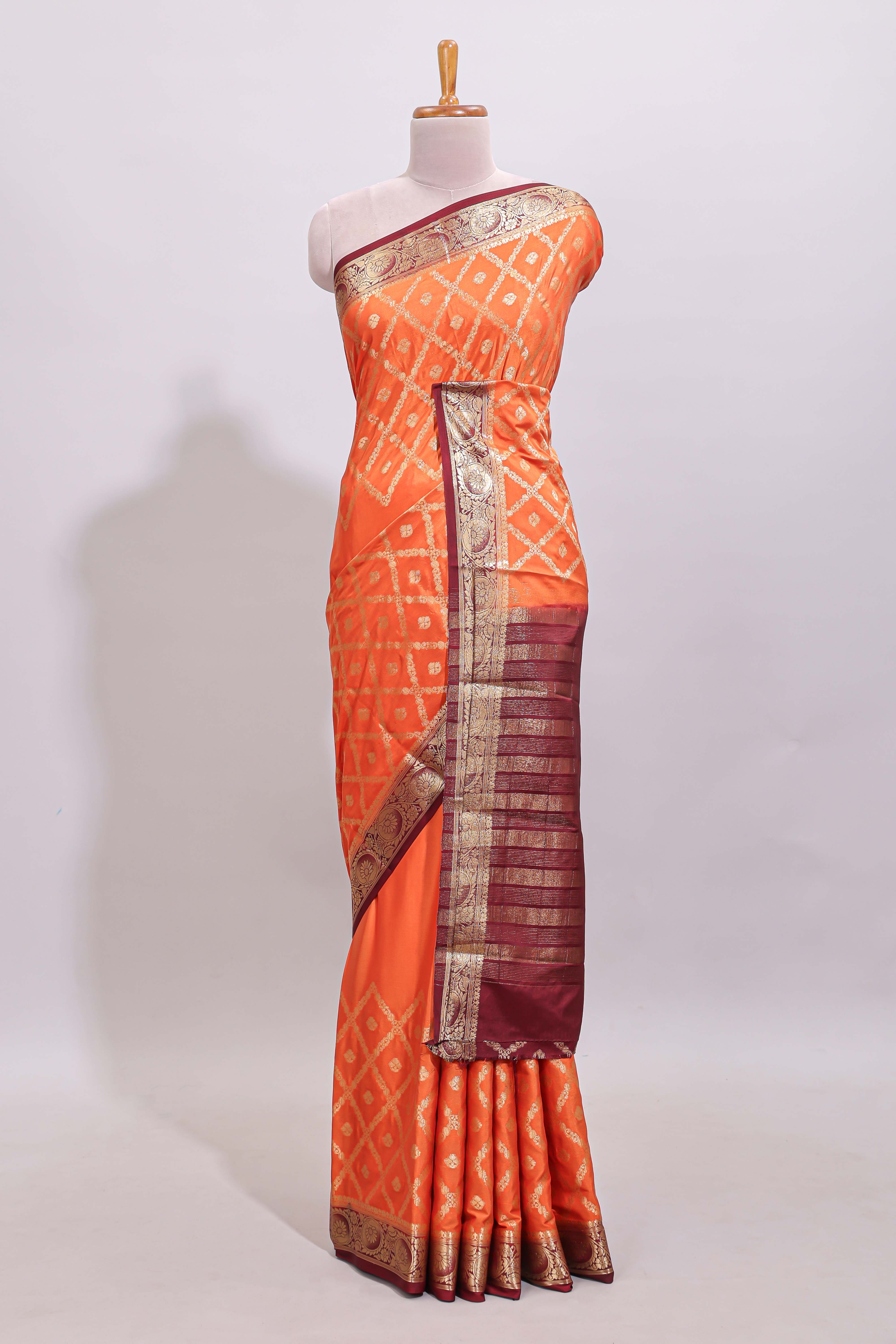 Bright orange jaal pattern with small floral motifs art mysore silk saree with contrast border and blouse