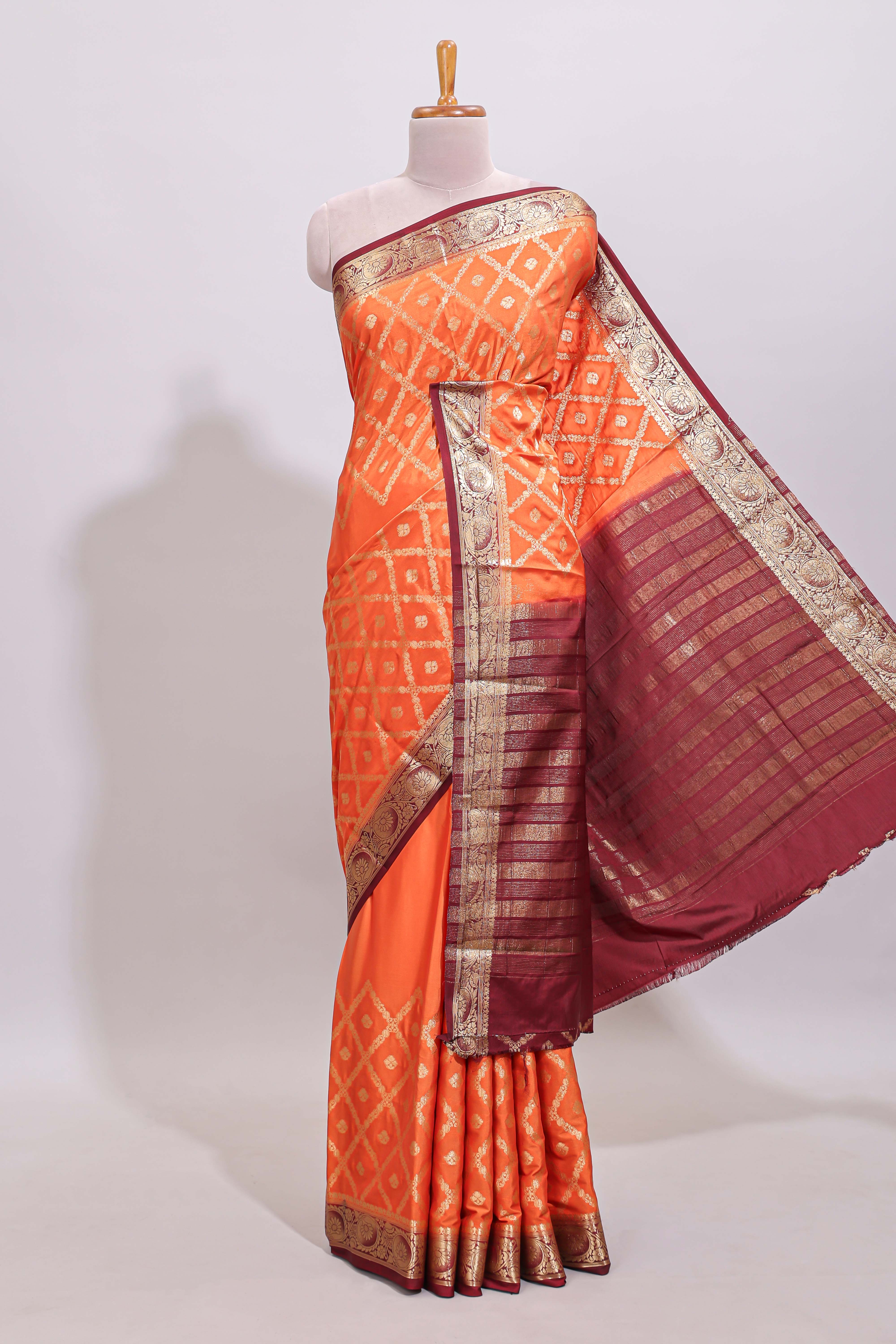 Bright orange jaal pattern with small floral motifs art mysore silk saree with contrast border and blouse