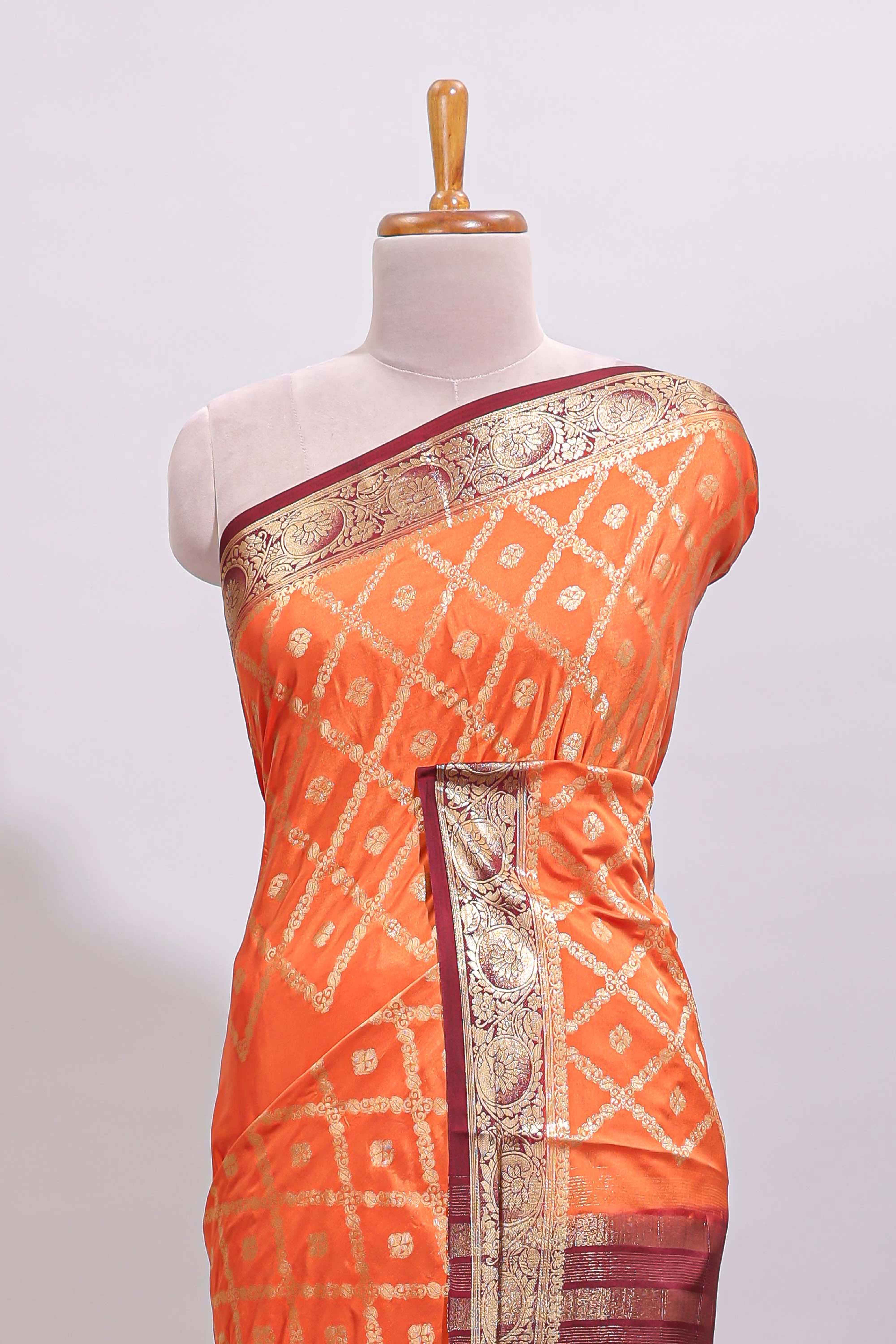 Bright orange jaal pattern with small floral motifs art mysore silk saree with contrast border and blouse